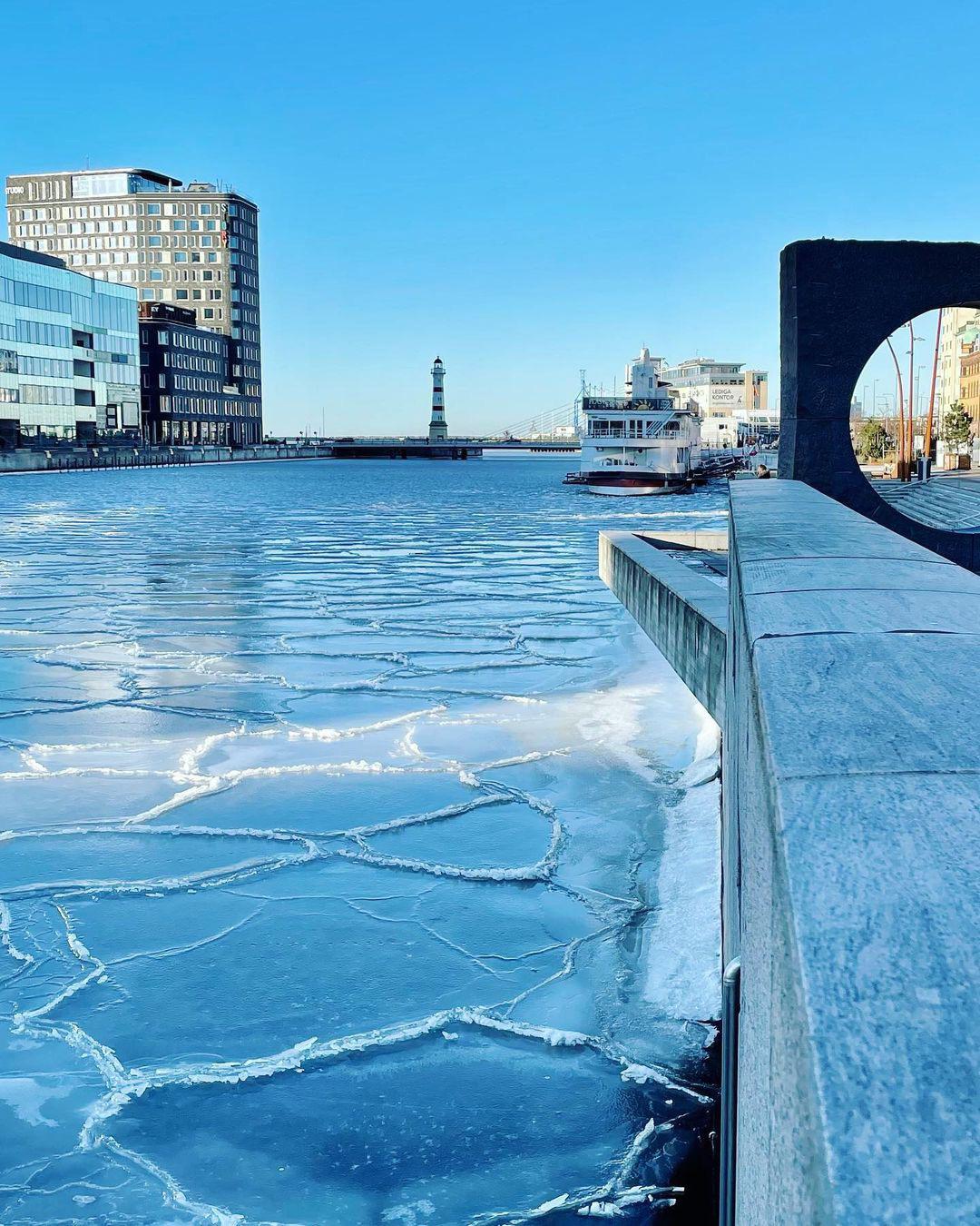 Frozen harbor in Malmö, Sweden. r/winterporn