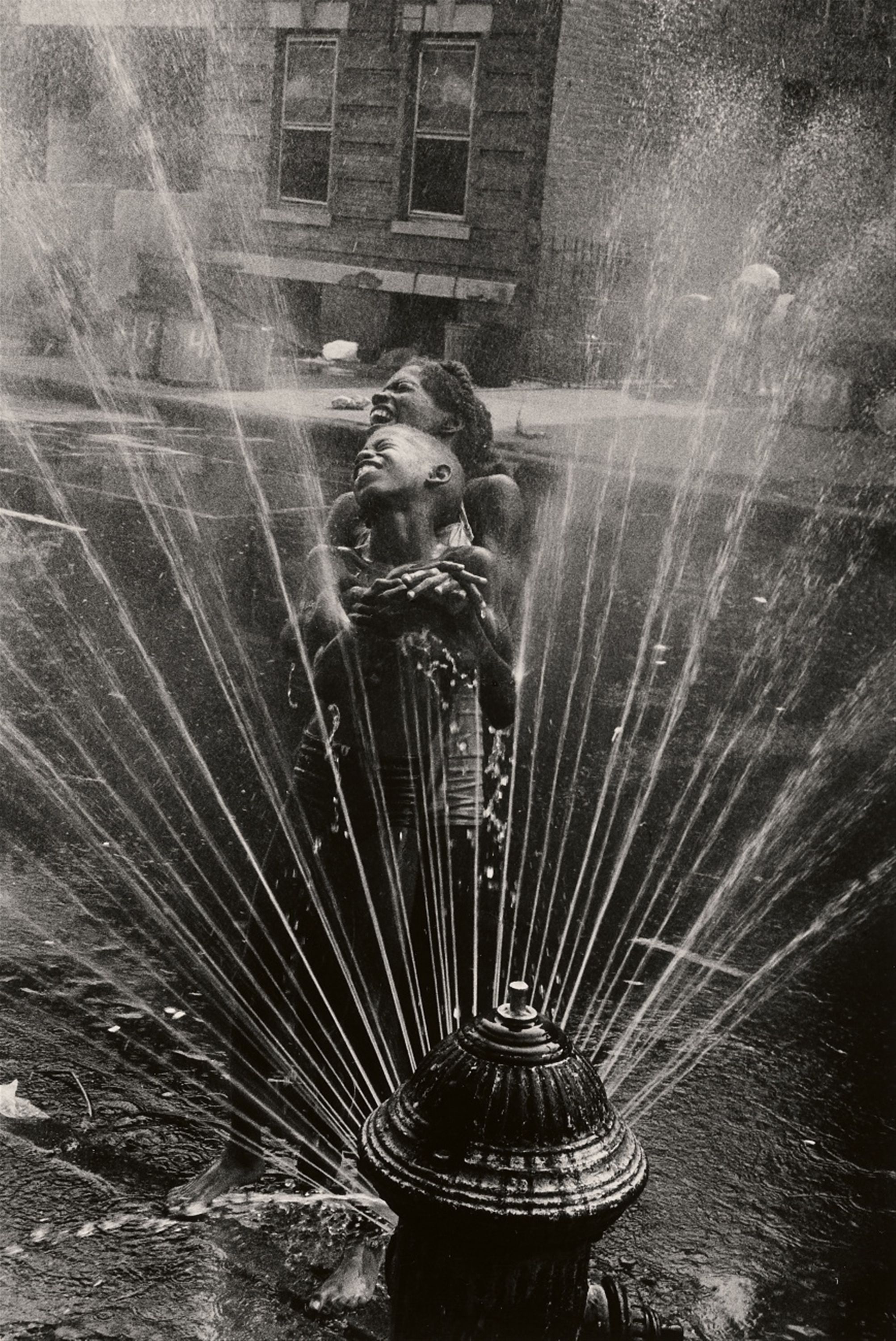The fire hydrants are opened during the summer heat, Harlem, New York