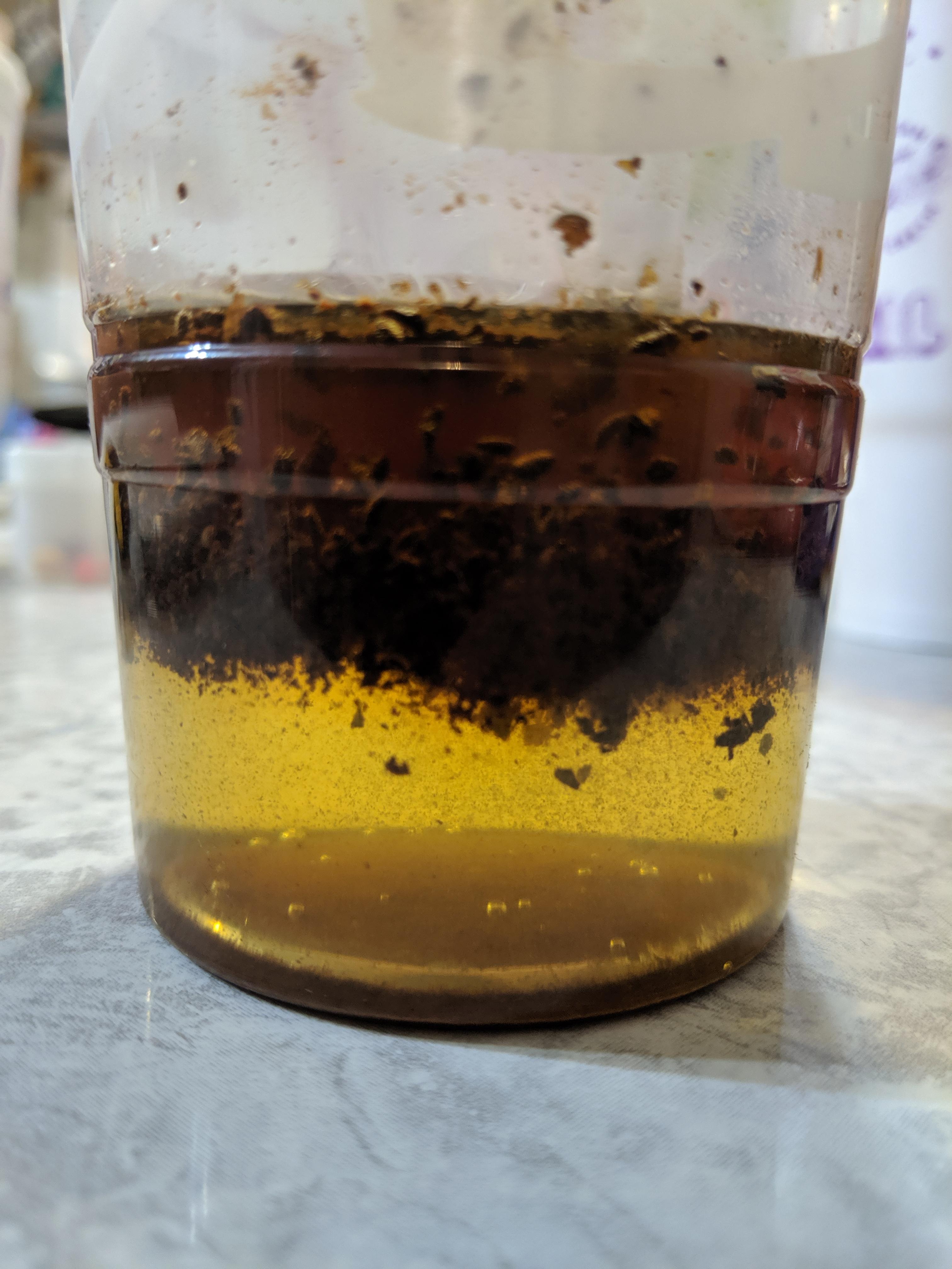 The way the coffee grounds float on whiskey r/mildlyinteresting