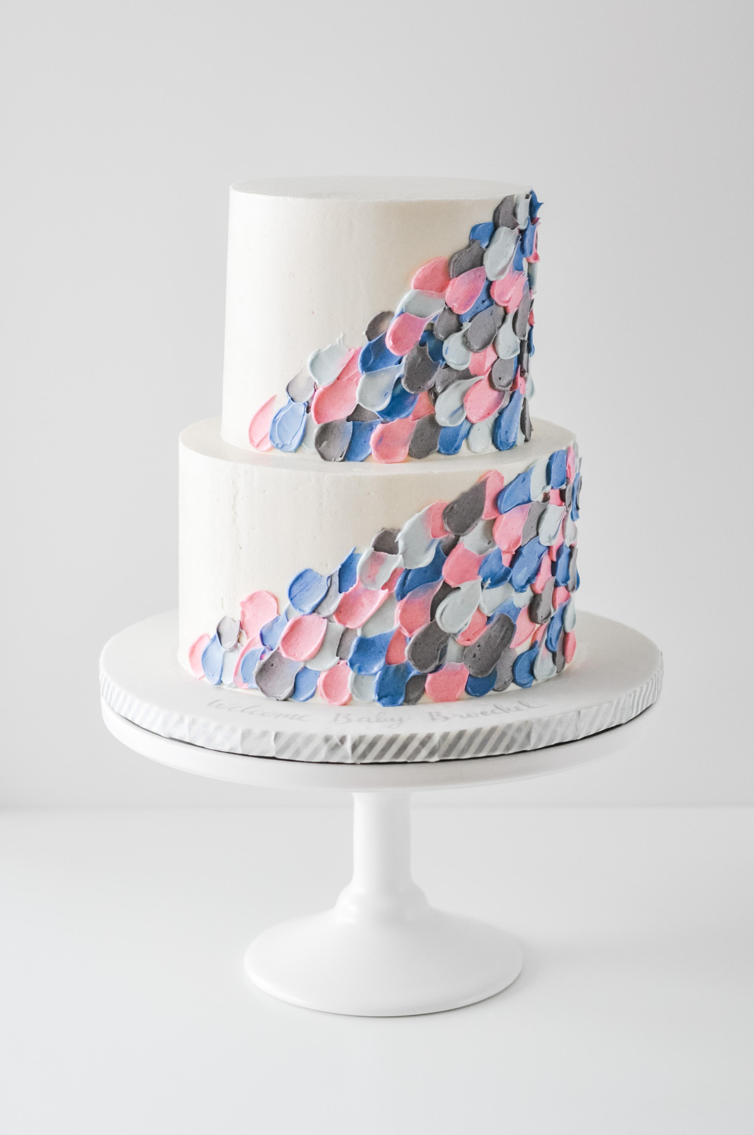 A buttercream palette knife painted gender neutral baby shower cake