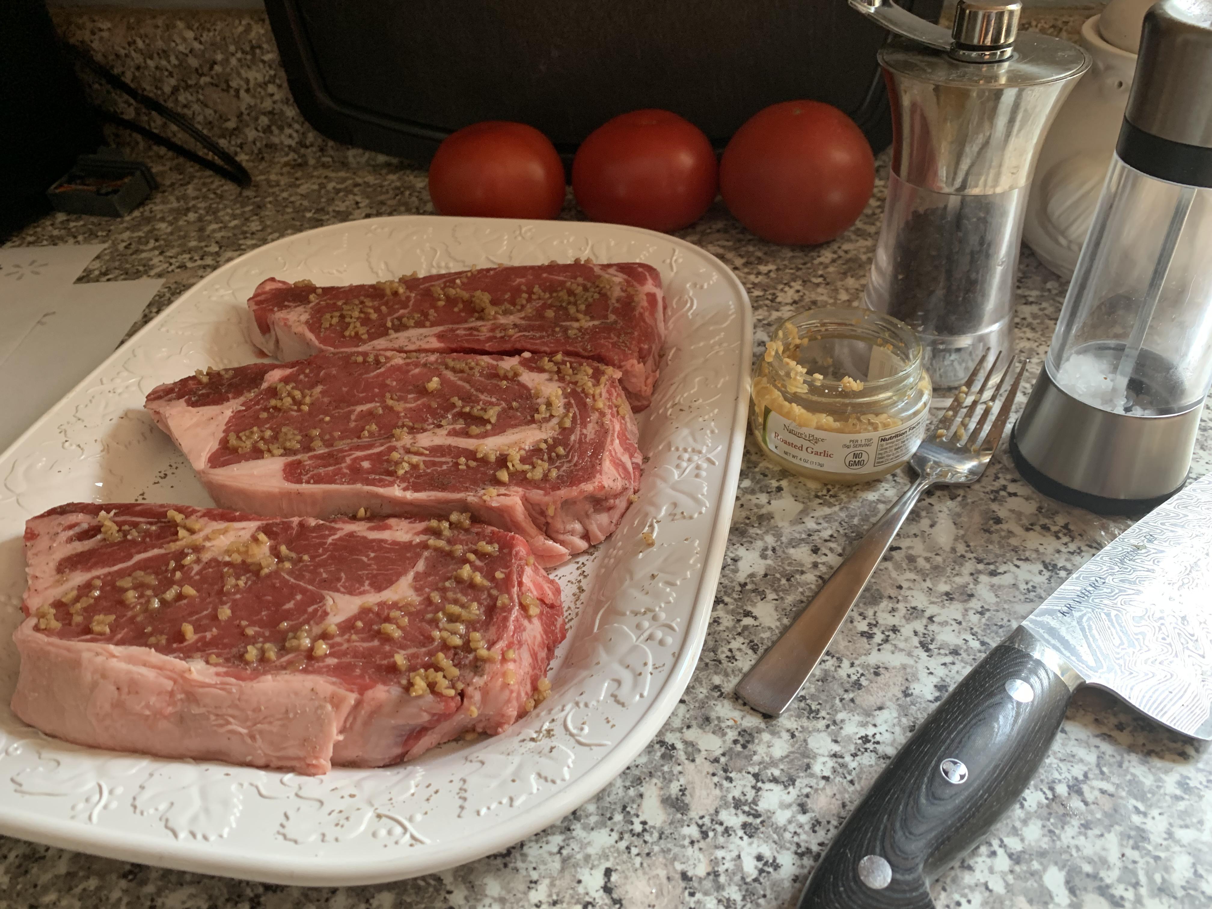 [homemade] Boneless ribeye steaks with salt pepper and roasted garlic