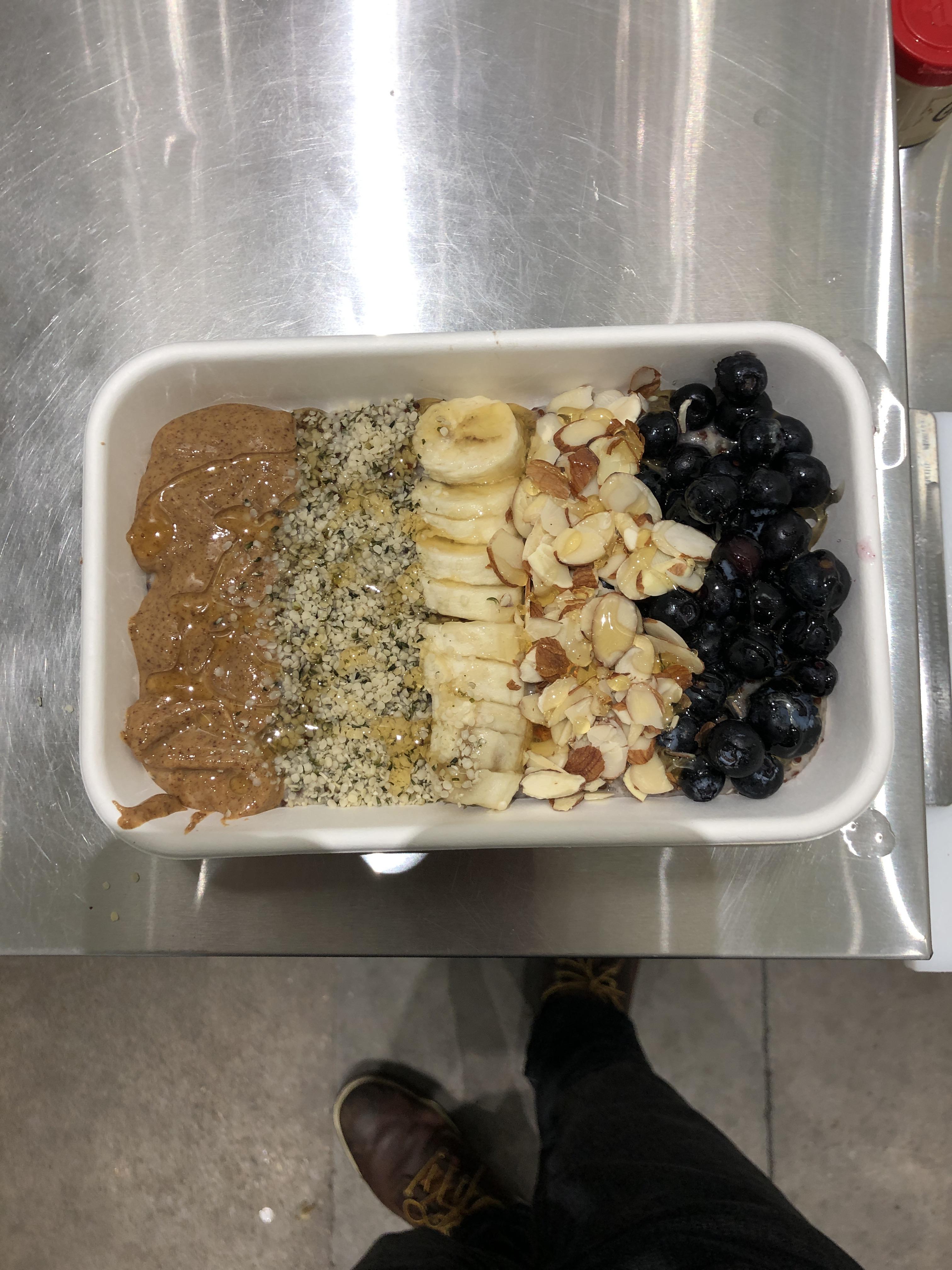 Almond butter, hemp seeds, banana, almonds and blueberries drizzled
