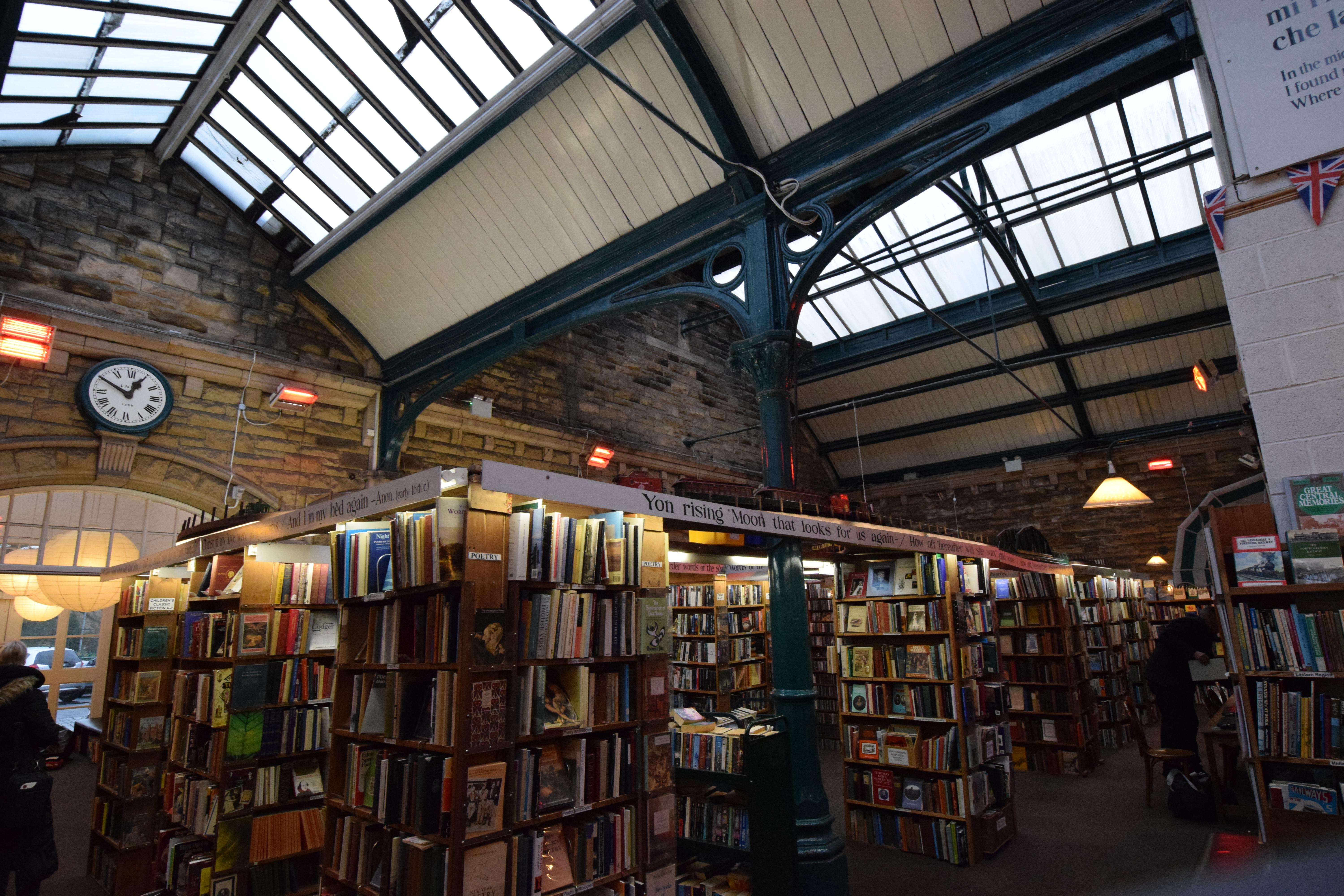 This old train station is now a book shop with model trains on the tops