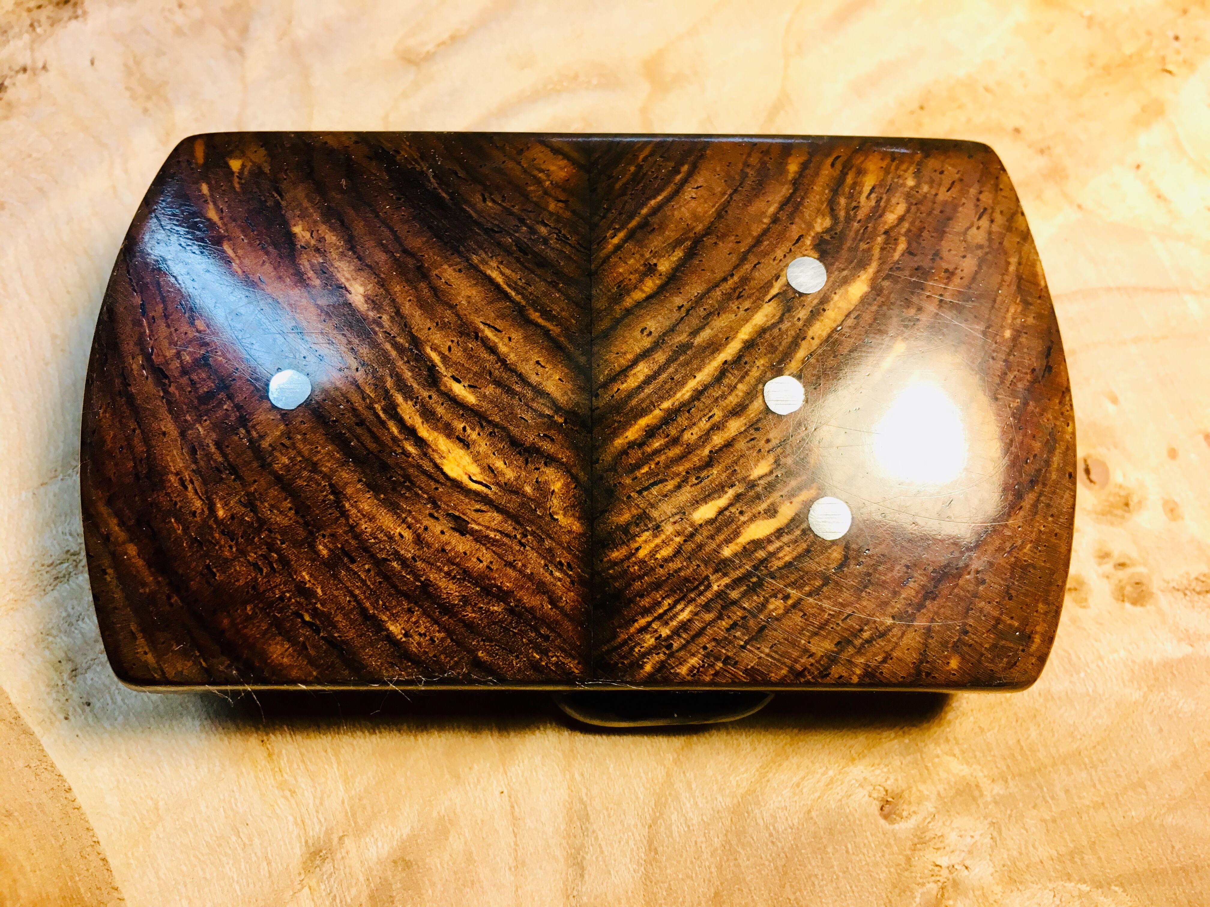 Closeups of handmade wooden belt buckles I made from a variety of