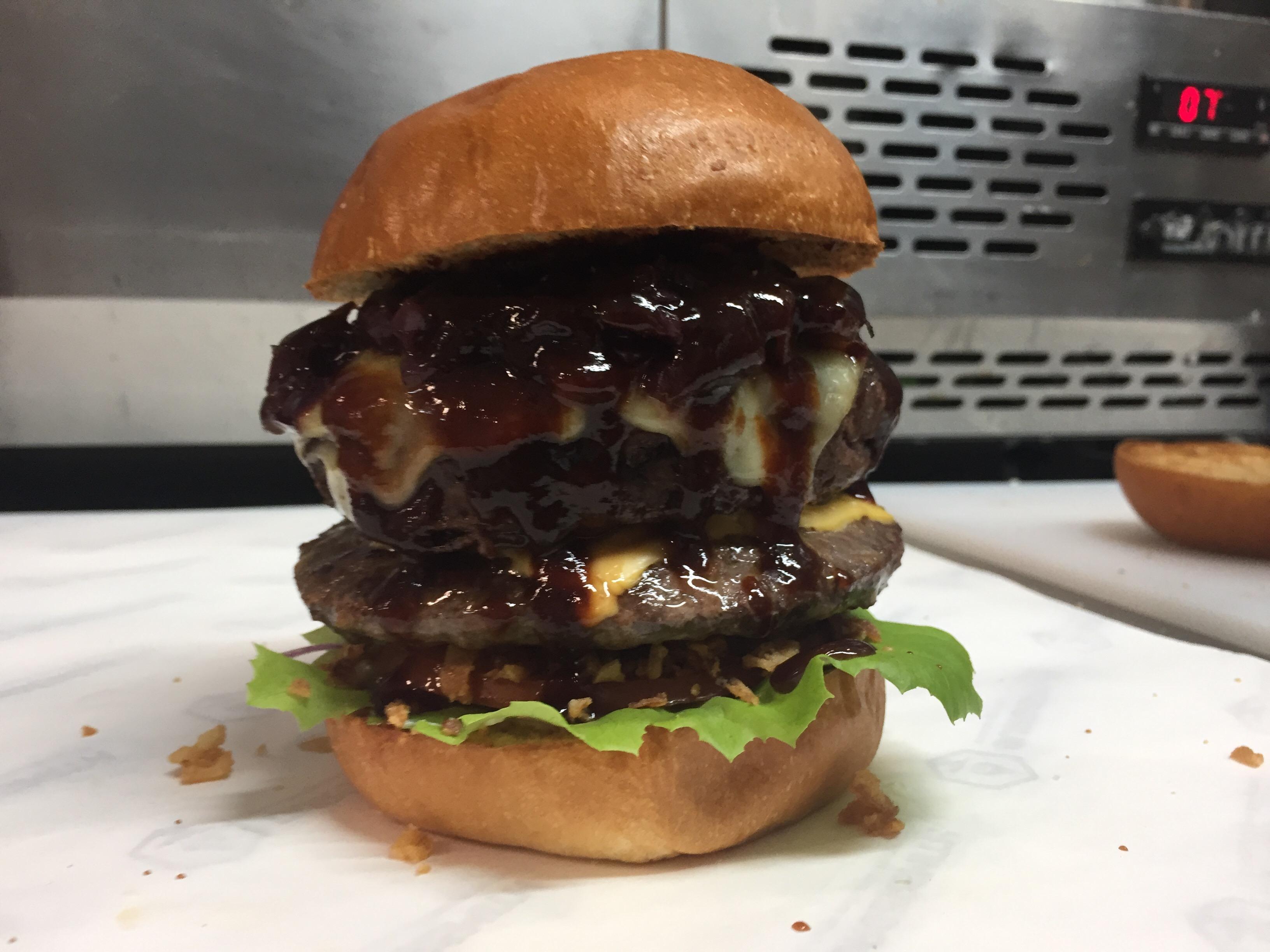 Ostrich and kangaroo burger with american cheese, caramelised onions