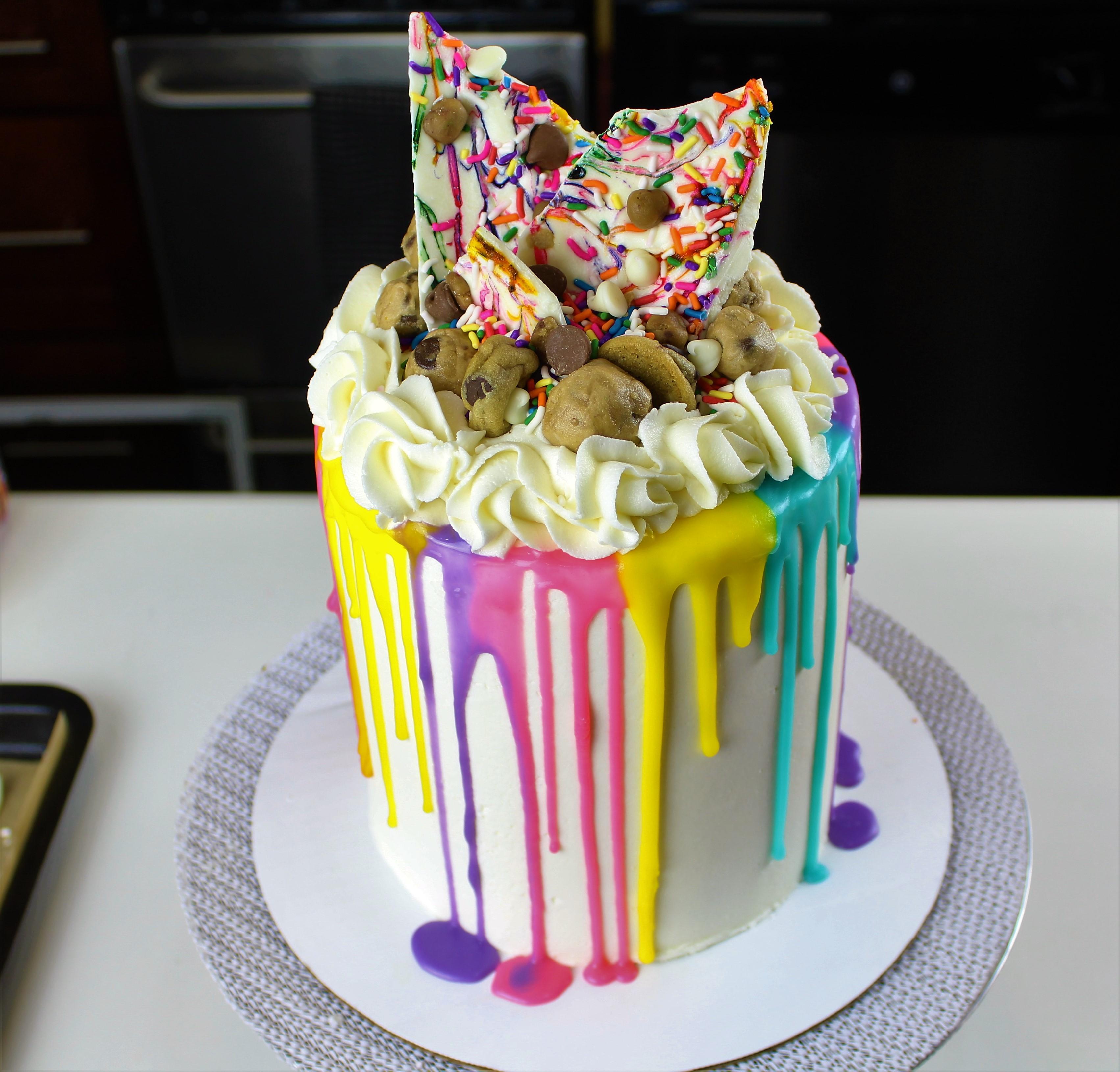 Learn how to decorate an Easy Colorful Drip Cake with Edible Cookie