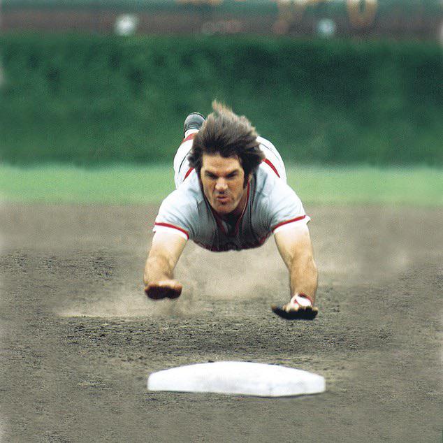 Pete Rose dives into third base in a game against the Chicago Cubs on