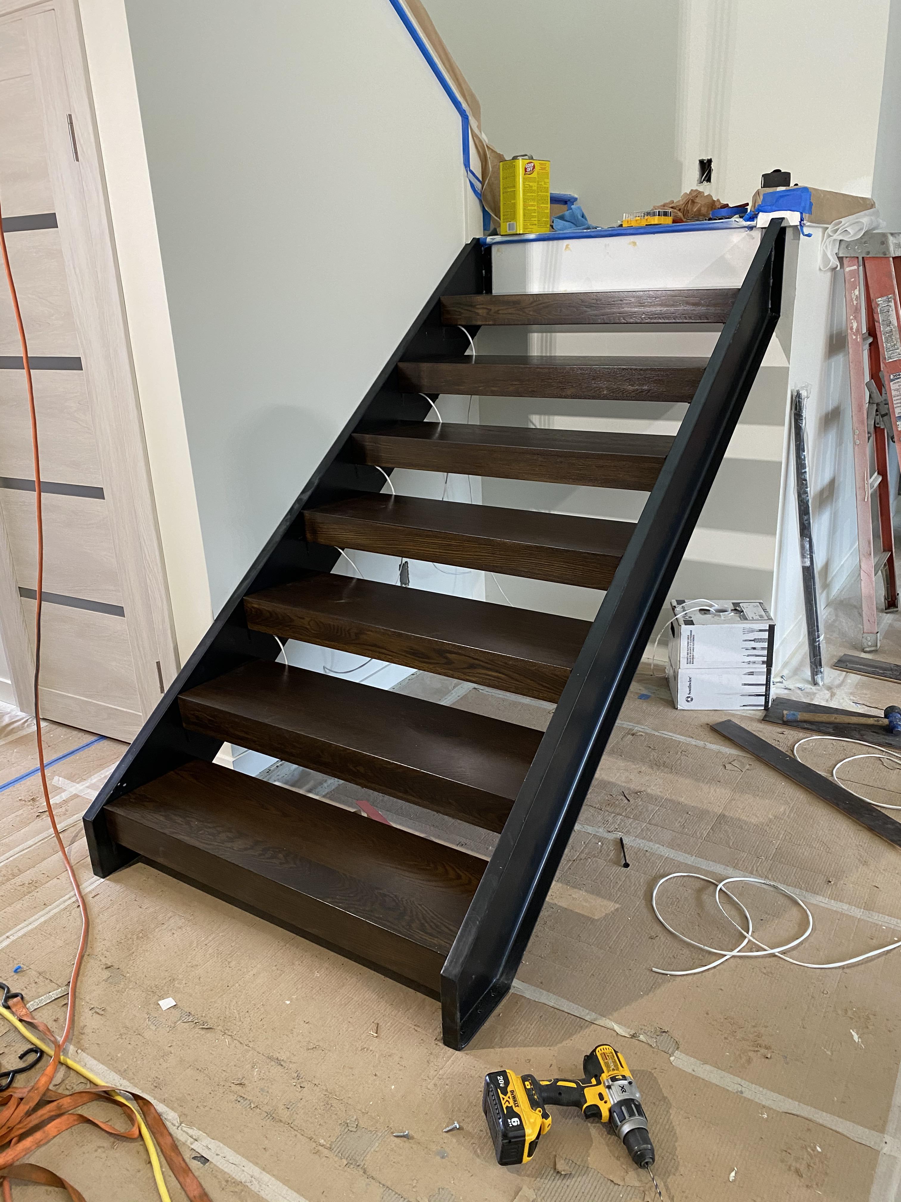 Steel CChannel stringers. Stained oak stair treads. My first attempt