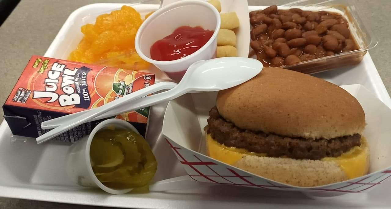 An example of a school lunch where I live A cheeseburger, beans, smile