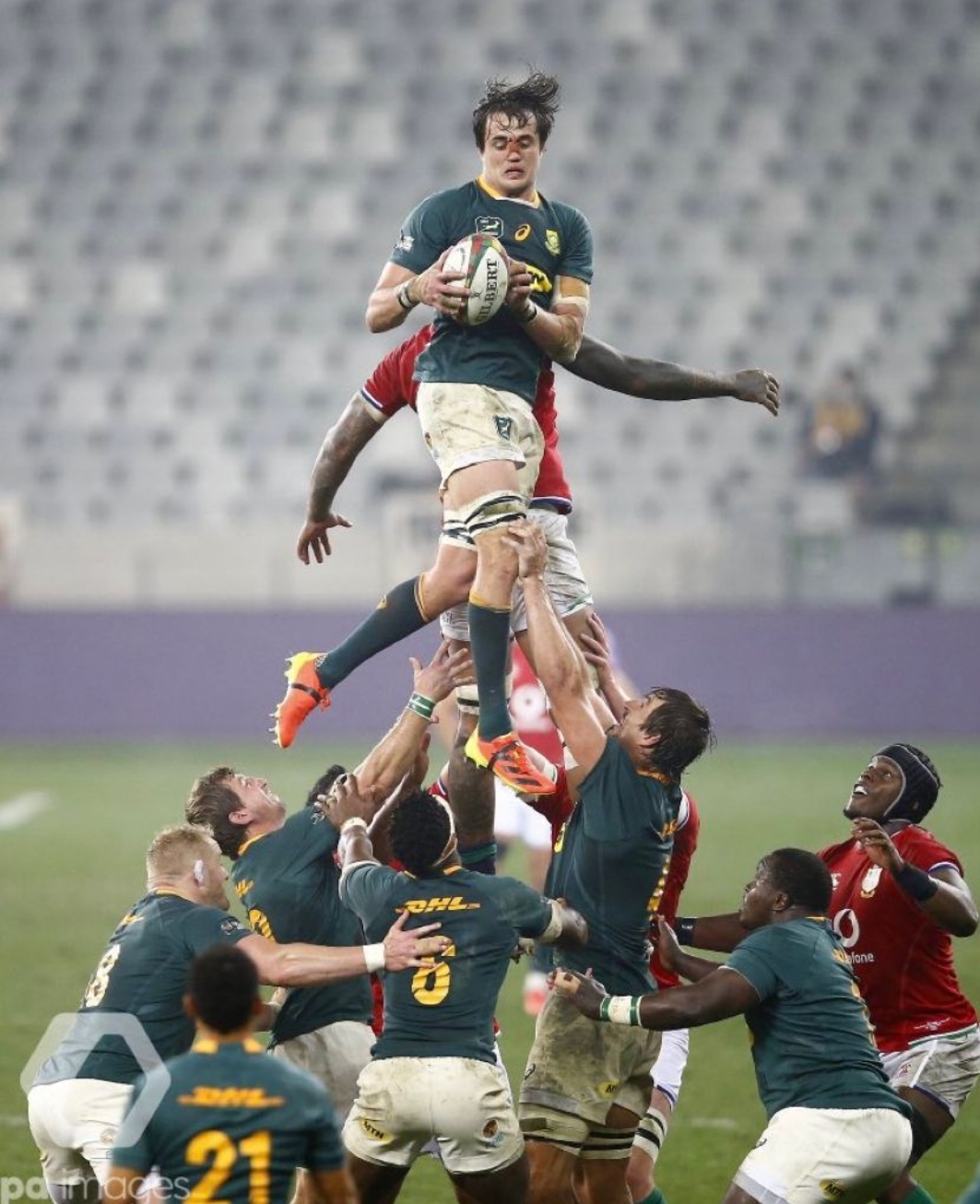 South African rugby player Franco Mostert being lifted by his teammates