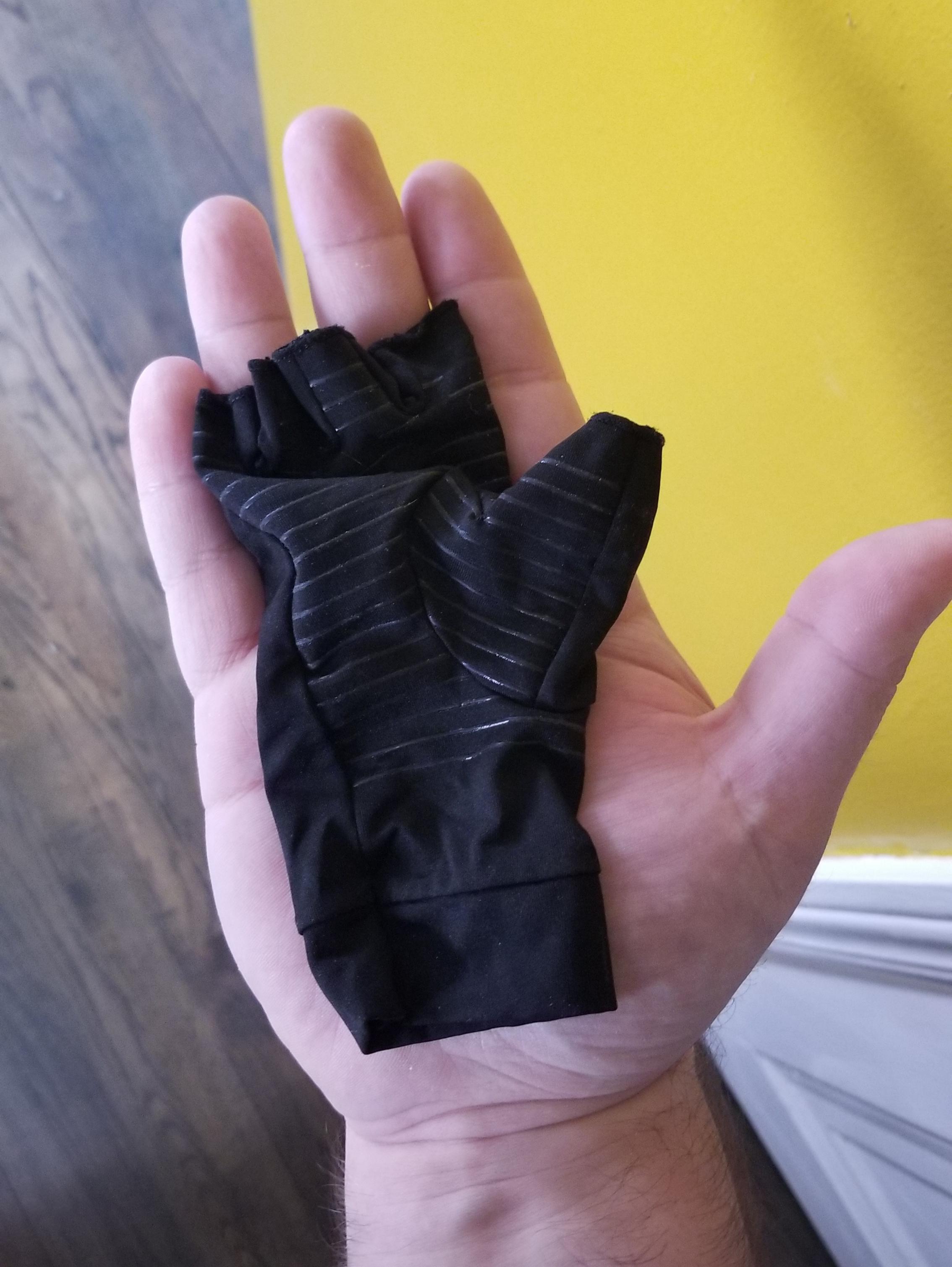 My girlfriend's tiny glove in my huge hand. r/mildlyinteresting