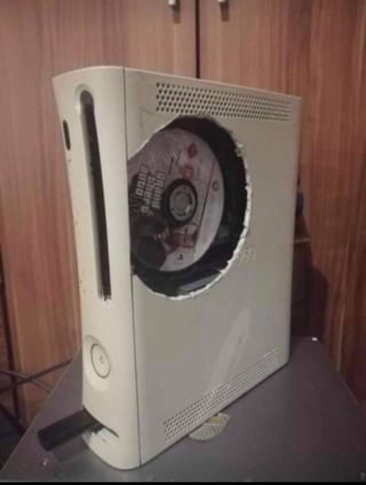 Disc tray stuck? No problem. Just cut a giant hole in your console 👍