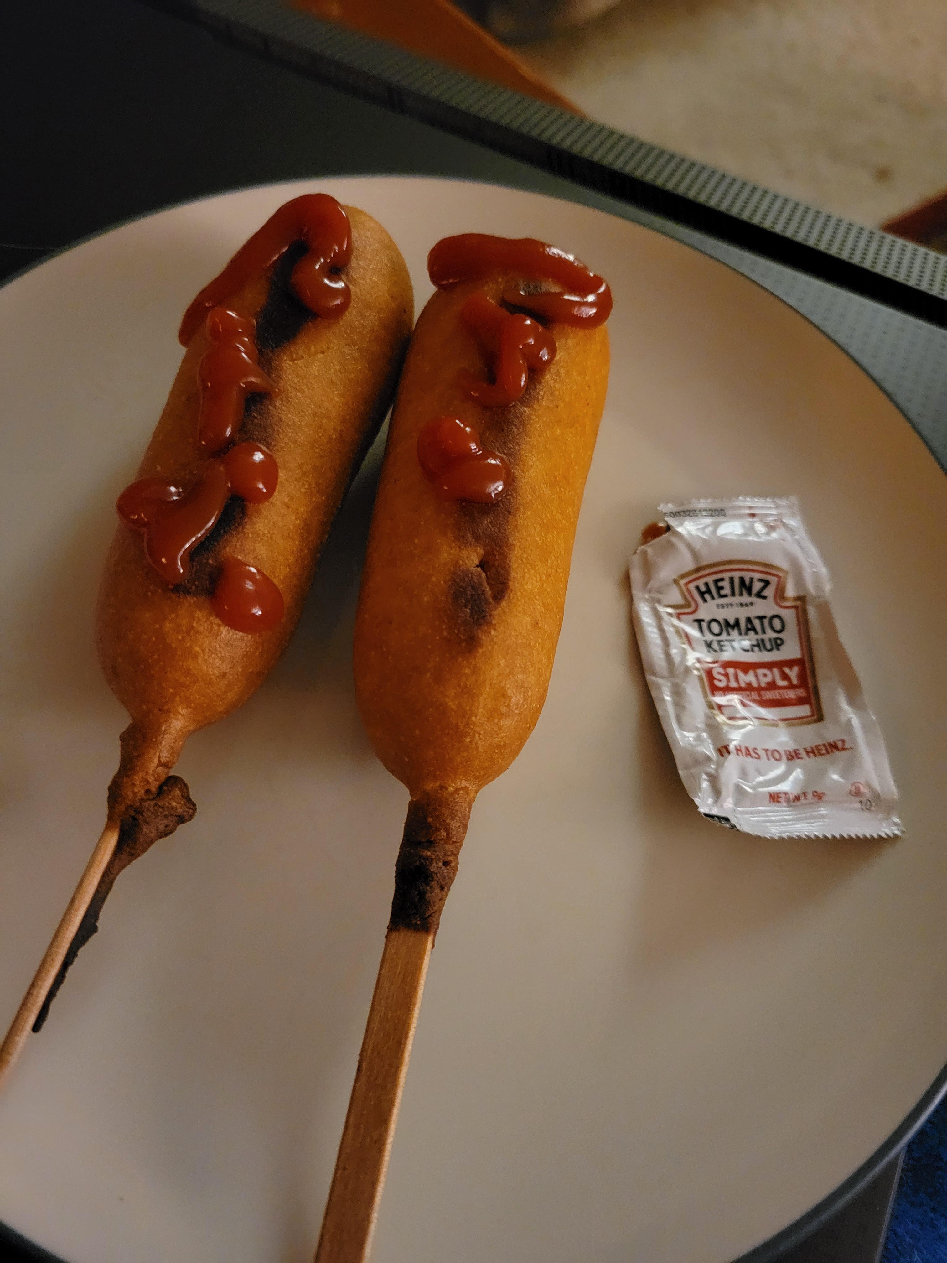 Burnt corn dogs with ketchup from a packet. r/ShittyVeganFoodPorn