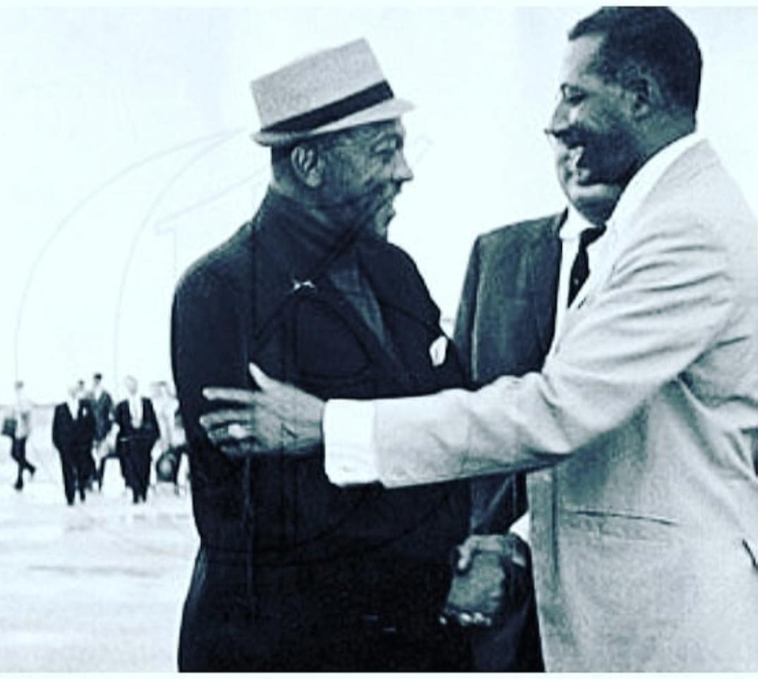 Herb McKenley (right) former Jamaican Olympic gold medallist, greets