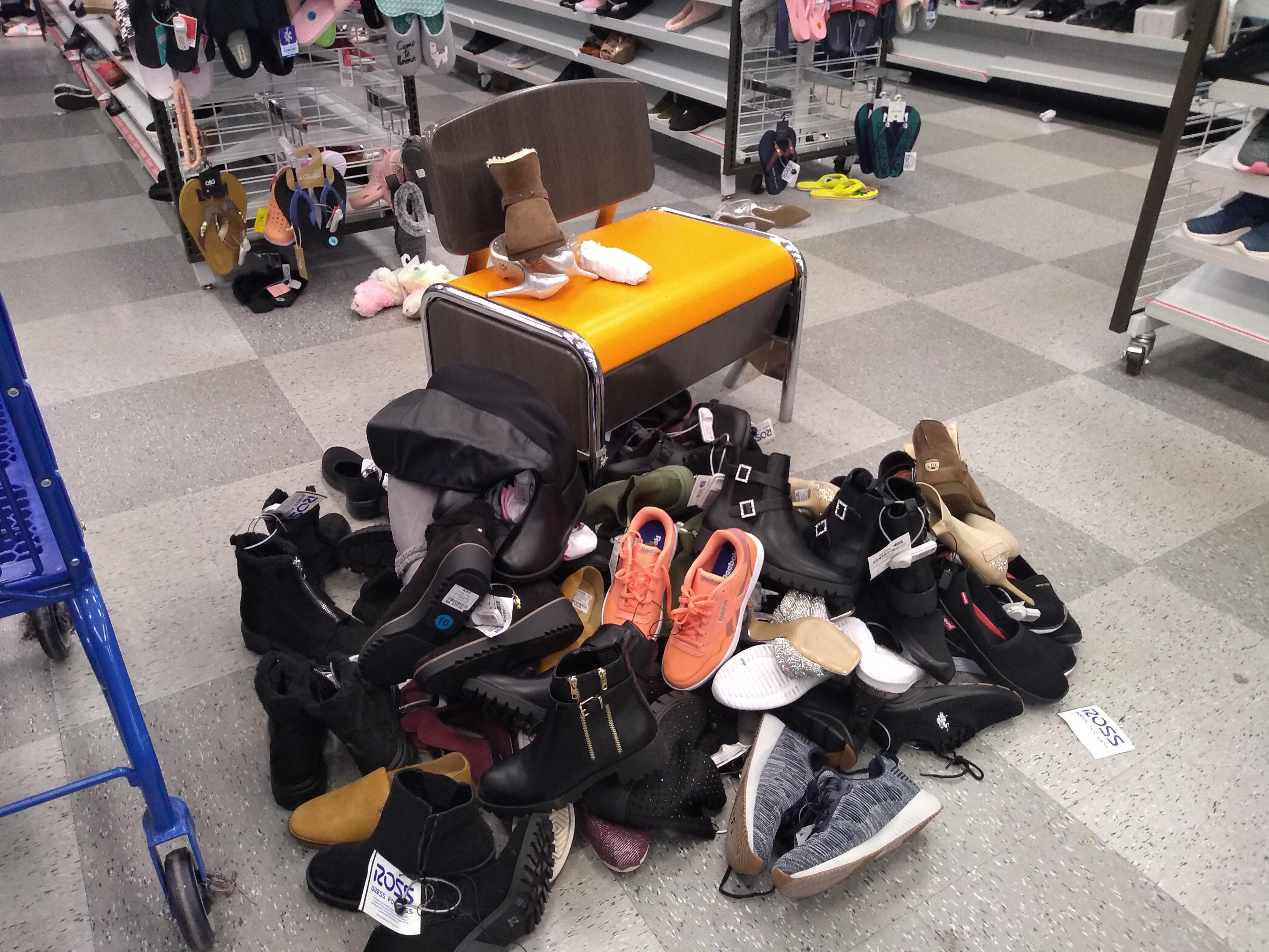 Someone tried on all these shoes and left them on the floor. r/trashy