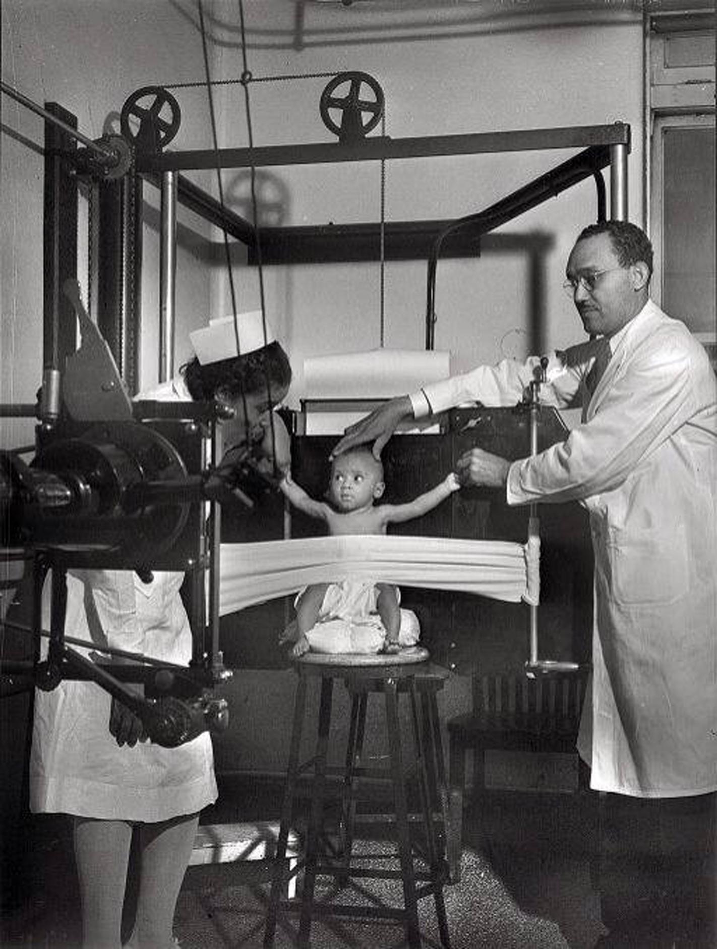 A baby is restrained for an xray at Provident Hospital in Chicago