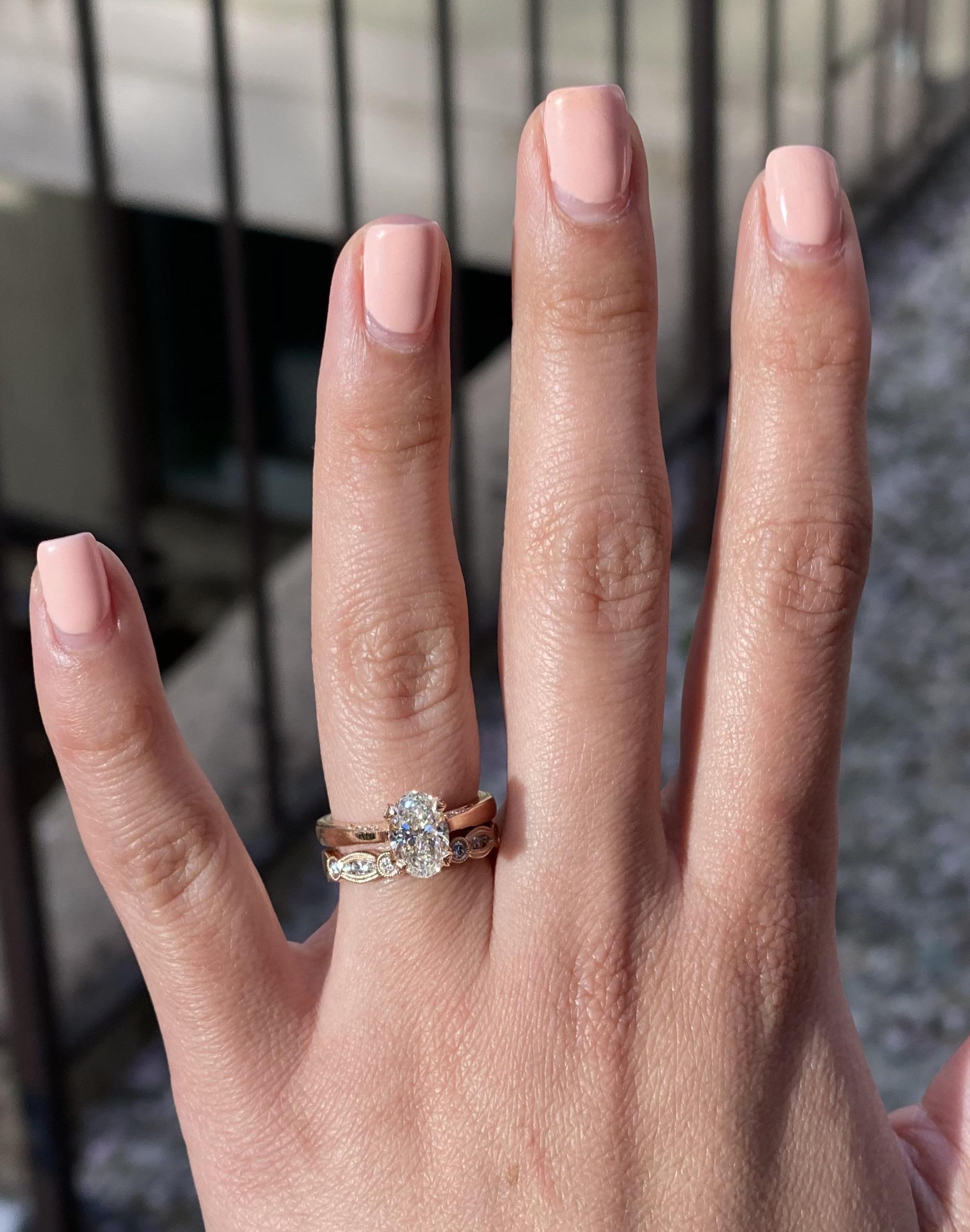 Custom oval diamond with rose gold engagement ring and band. Made by