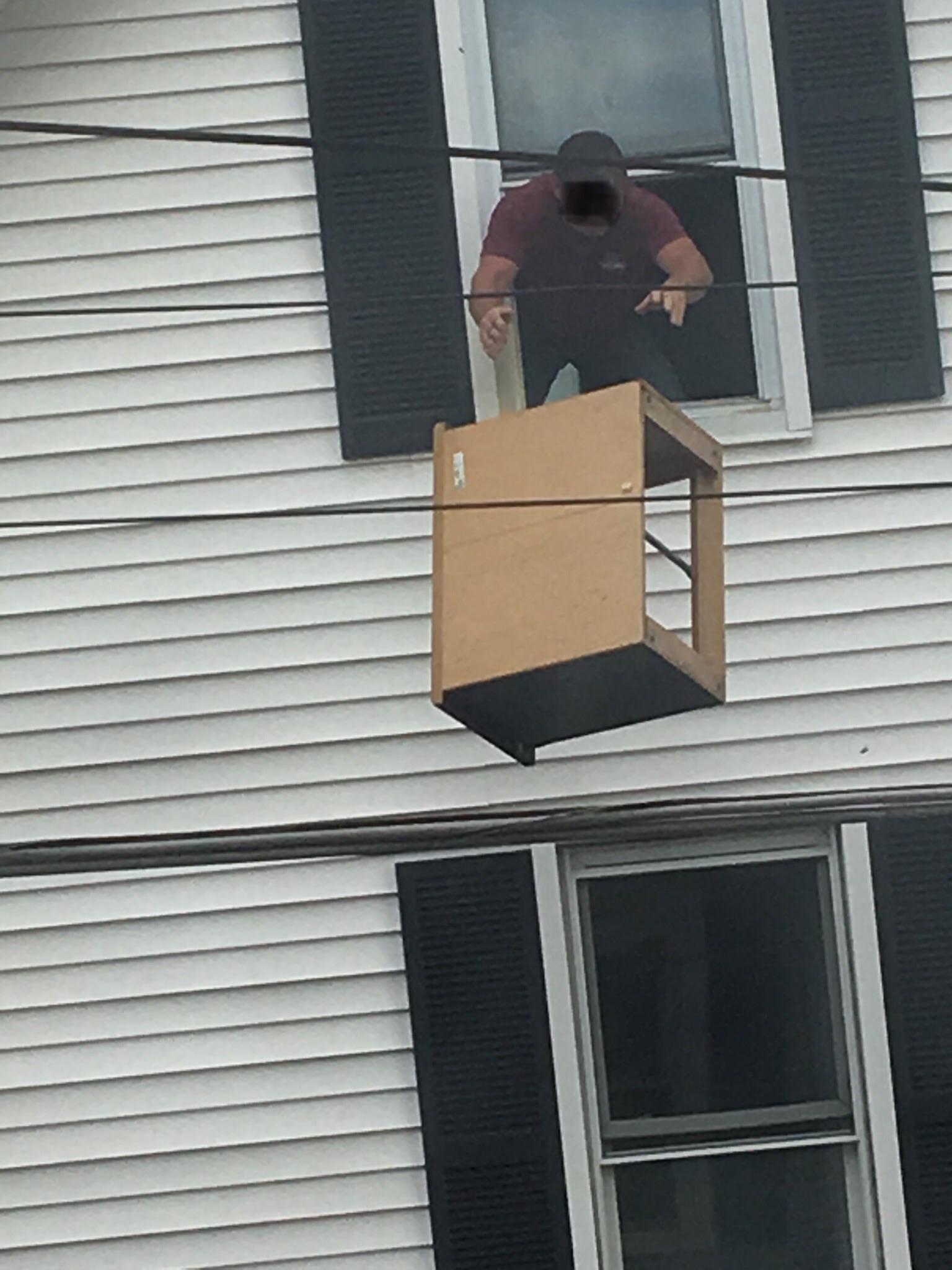 My neighbor nonchalantly tossing furniture out of his window. r/pics