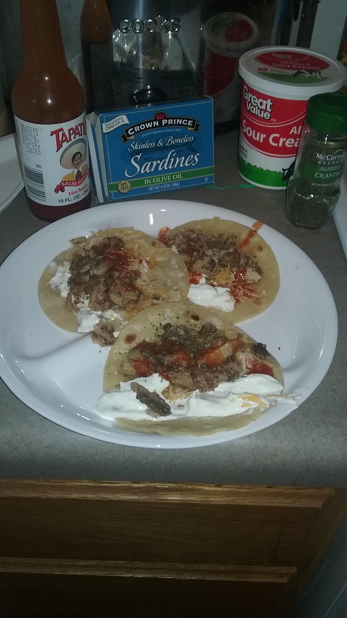 Sardine and cheese tacos, with sour cream, Tapatio, and dried cilantro