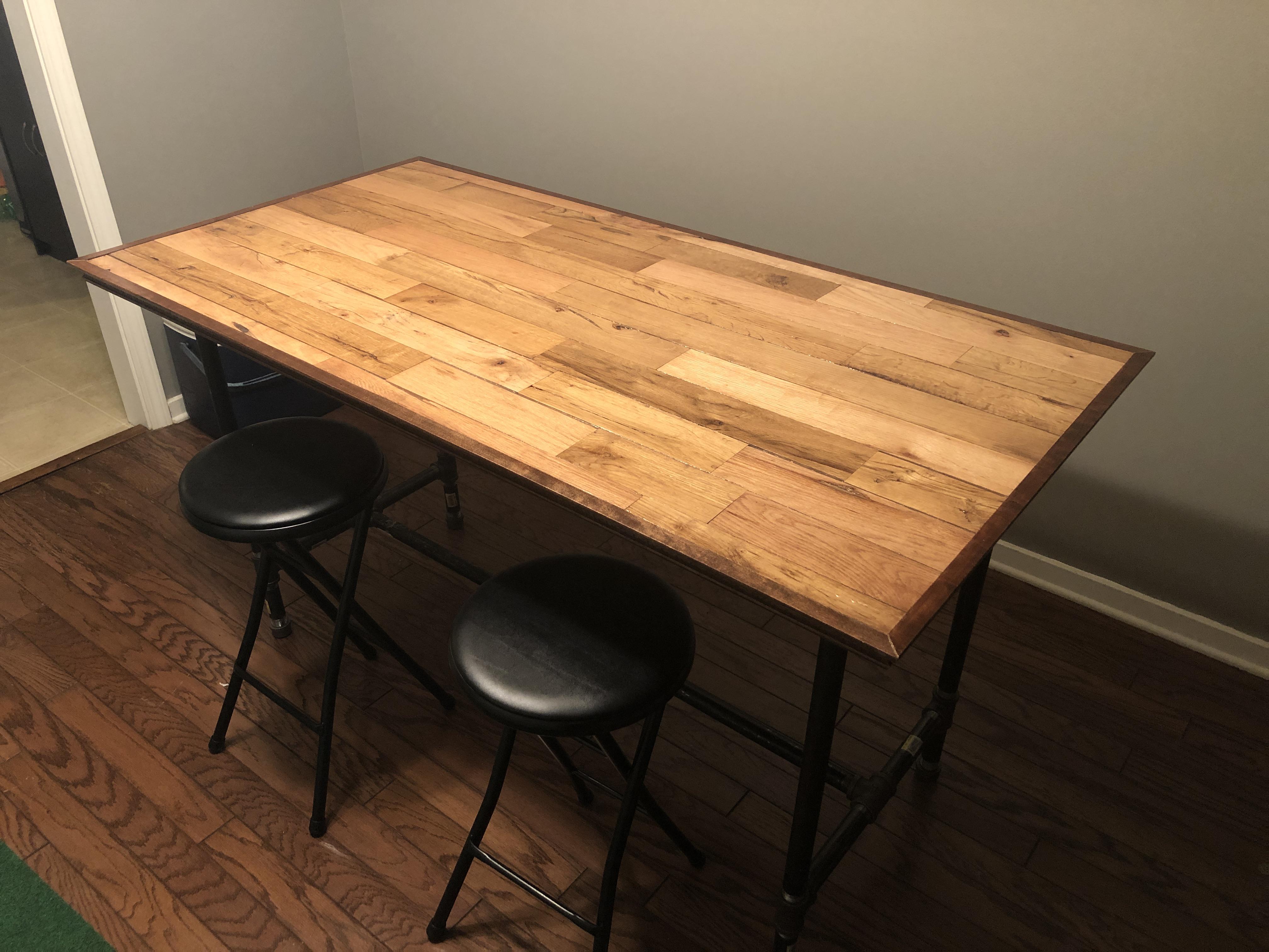 Table I made from leftover hardwood flooring and steel piping r