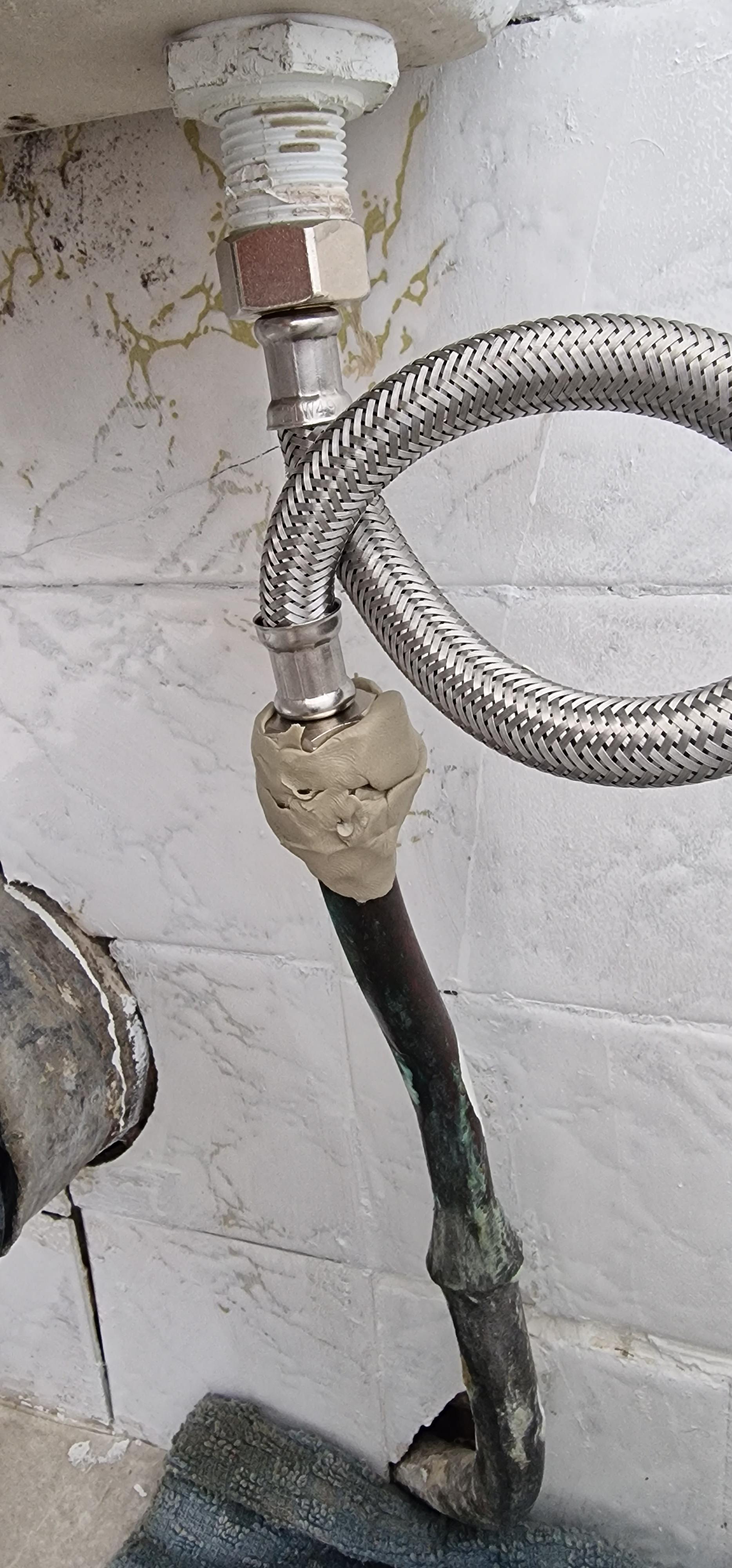 There's a leak on this copper valve but a plumber can't come out till