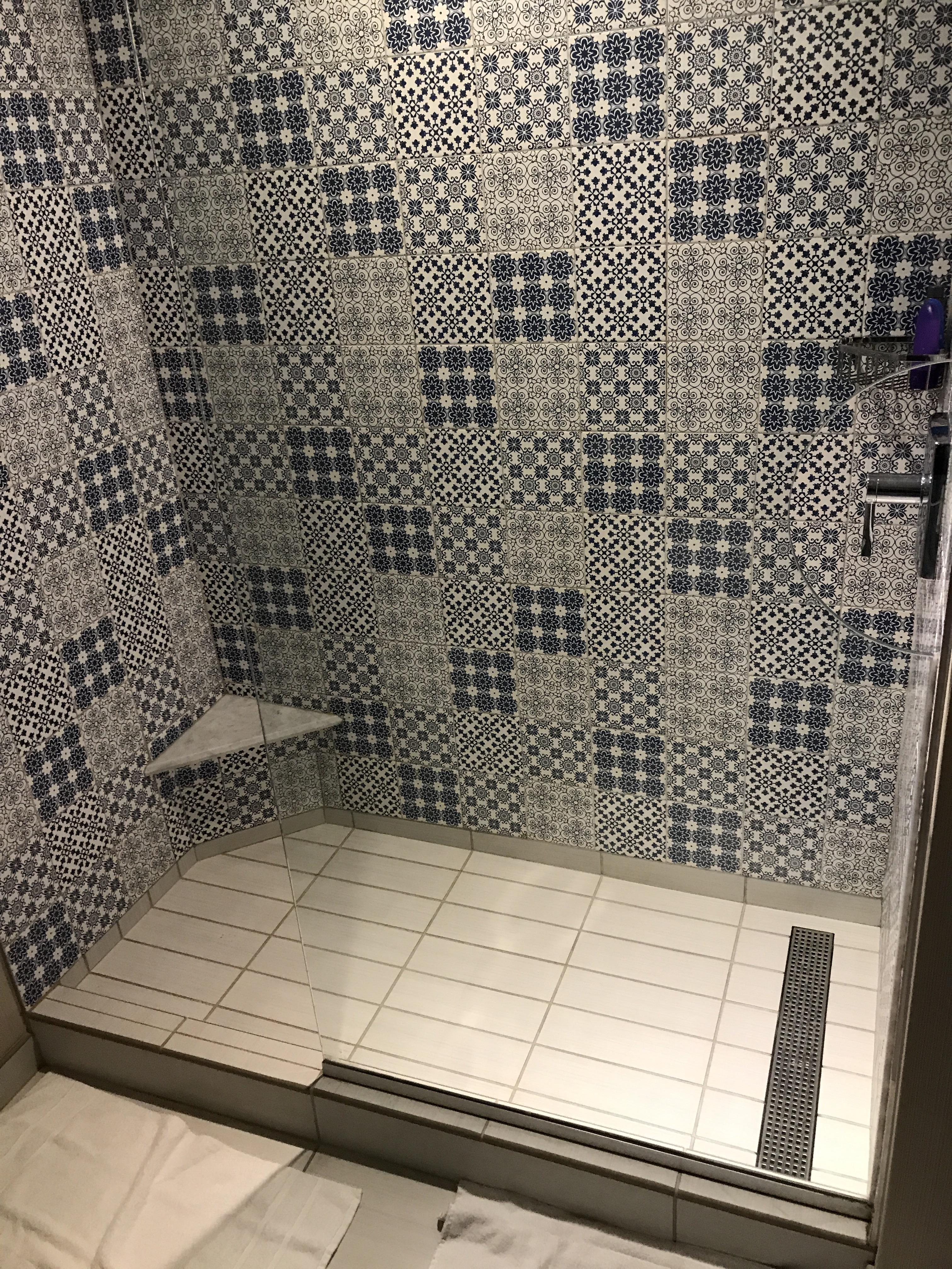 Open glass shower wall, hole for preshower access to the shower handle