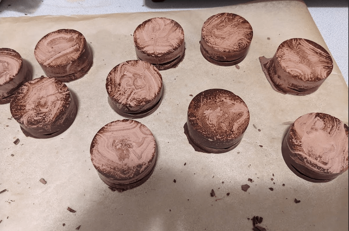 What is causing this discoloration when my tempered chocolate hardens