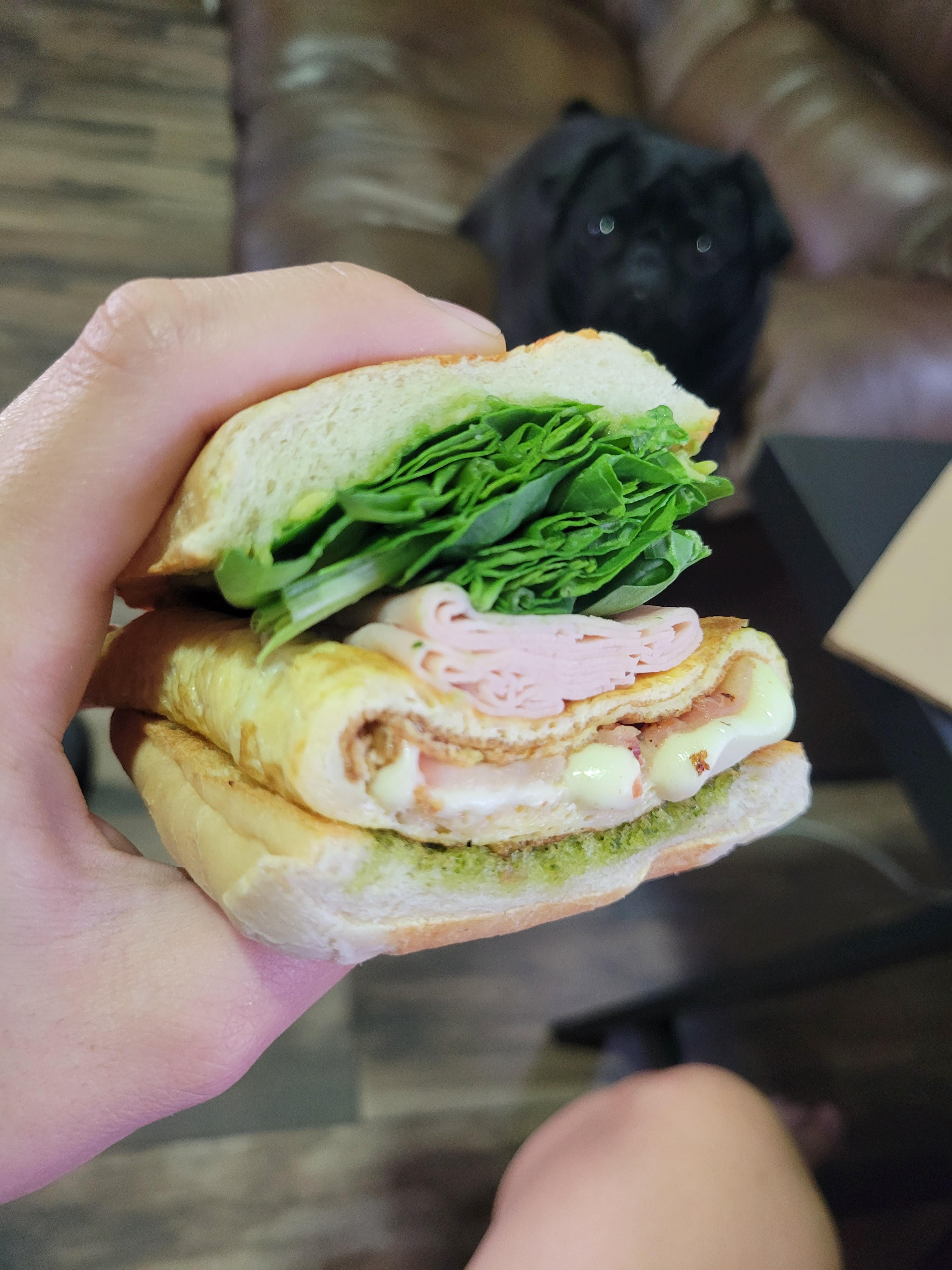 bacon and oaxaca cheese omelet with spinach and guacamole in a parmesan