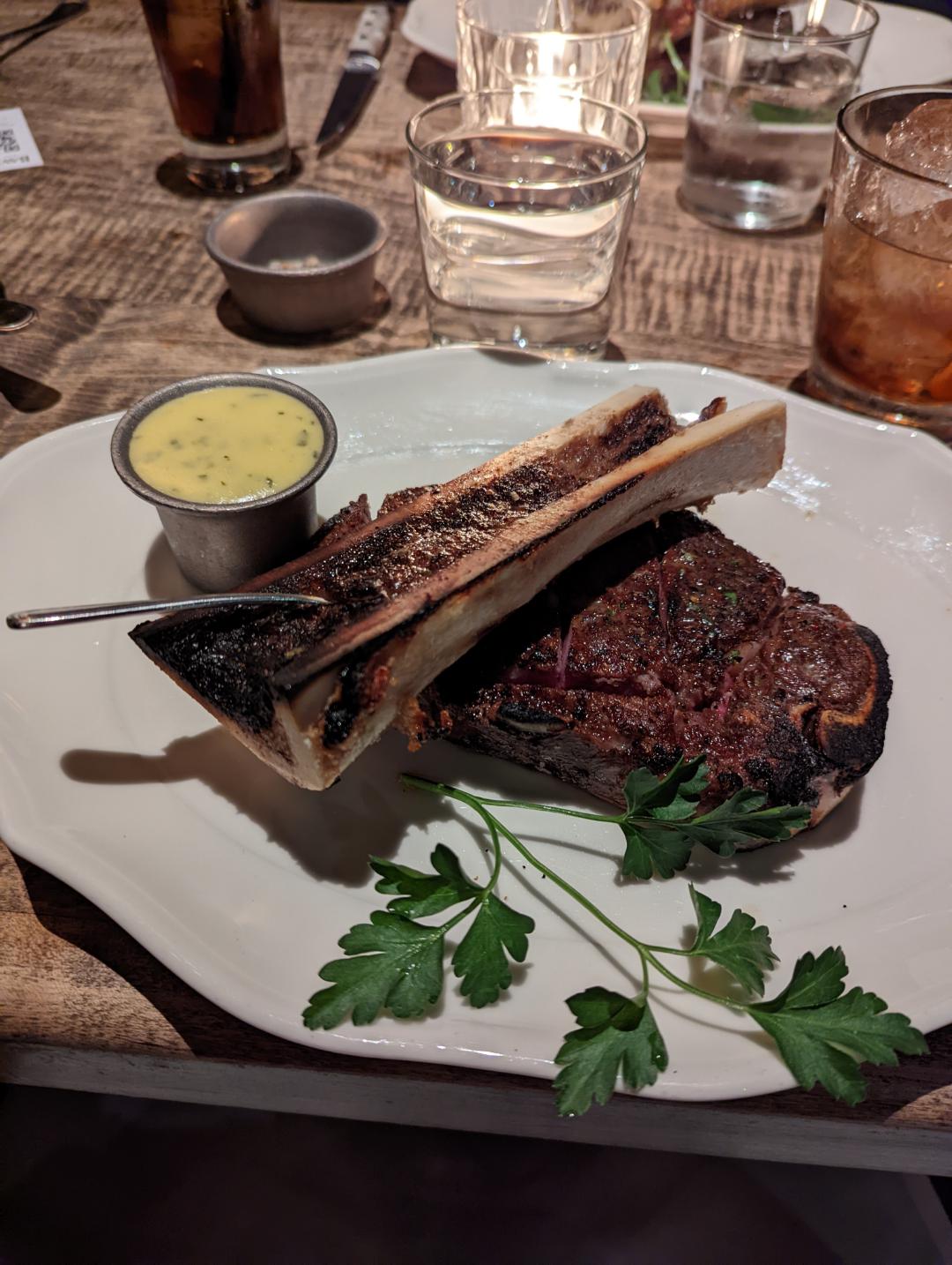 Dry aged bone in NY strip with Bone Marrow! steak