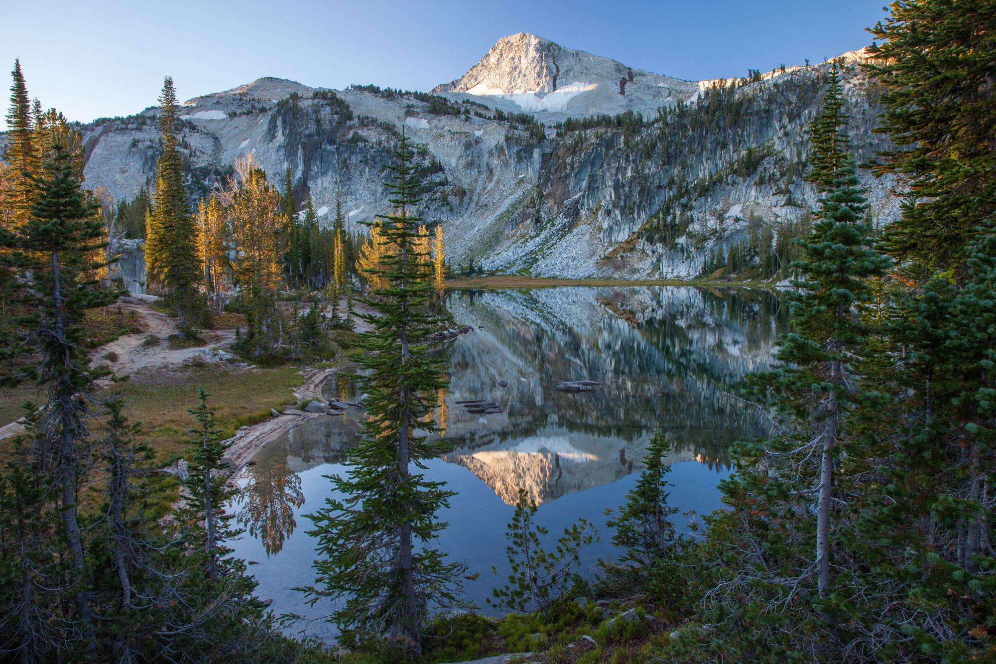 First touch of Sun on Eagle Cap Peak reflected in Mirror lake. Eagle