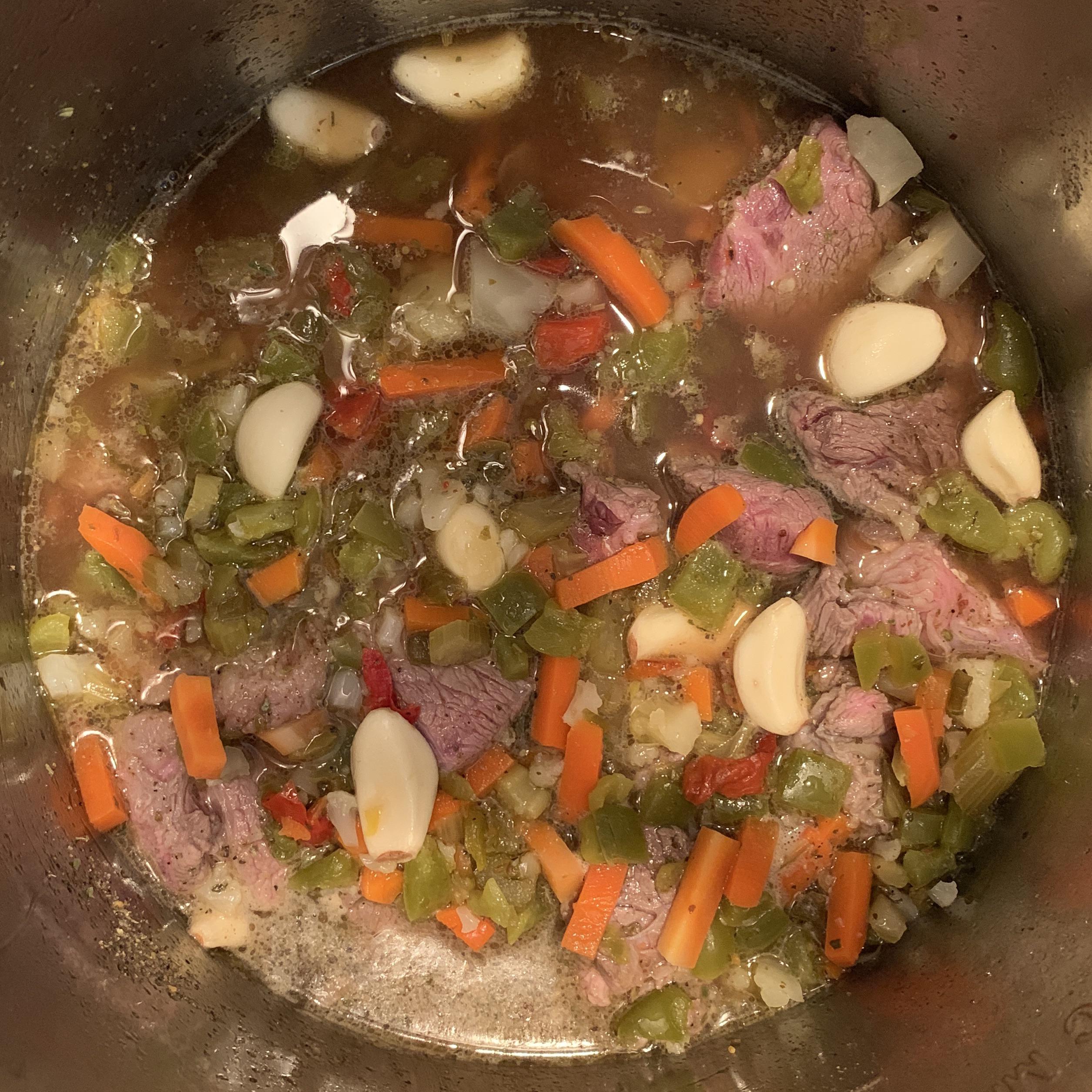 Slow cooker Italian beef. Aldi chuck roast and peeled garlic, cooked