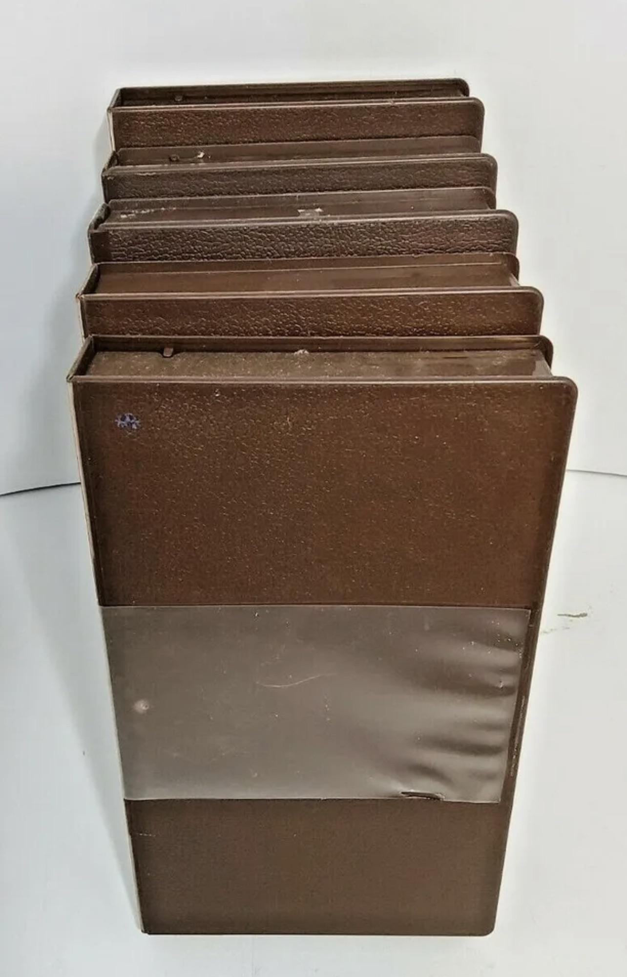 Brown plastic VHS cases with the plastic sleeve. Found at either your