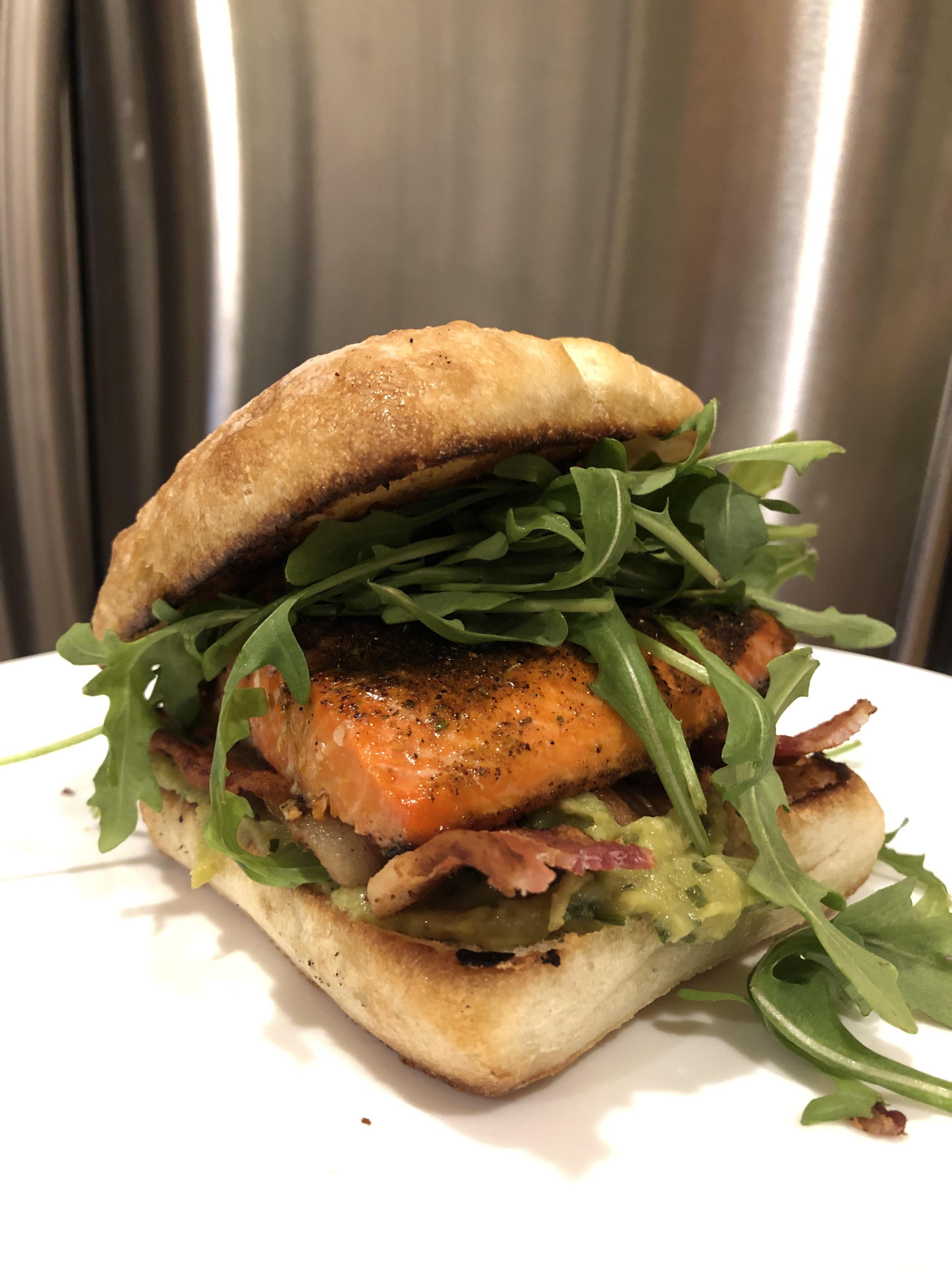 Broiled salmon on grilled buttered ciabatta bread with thick sliced