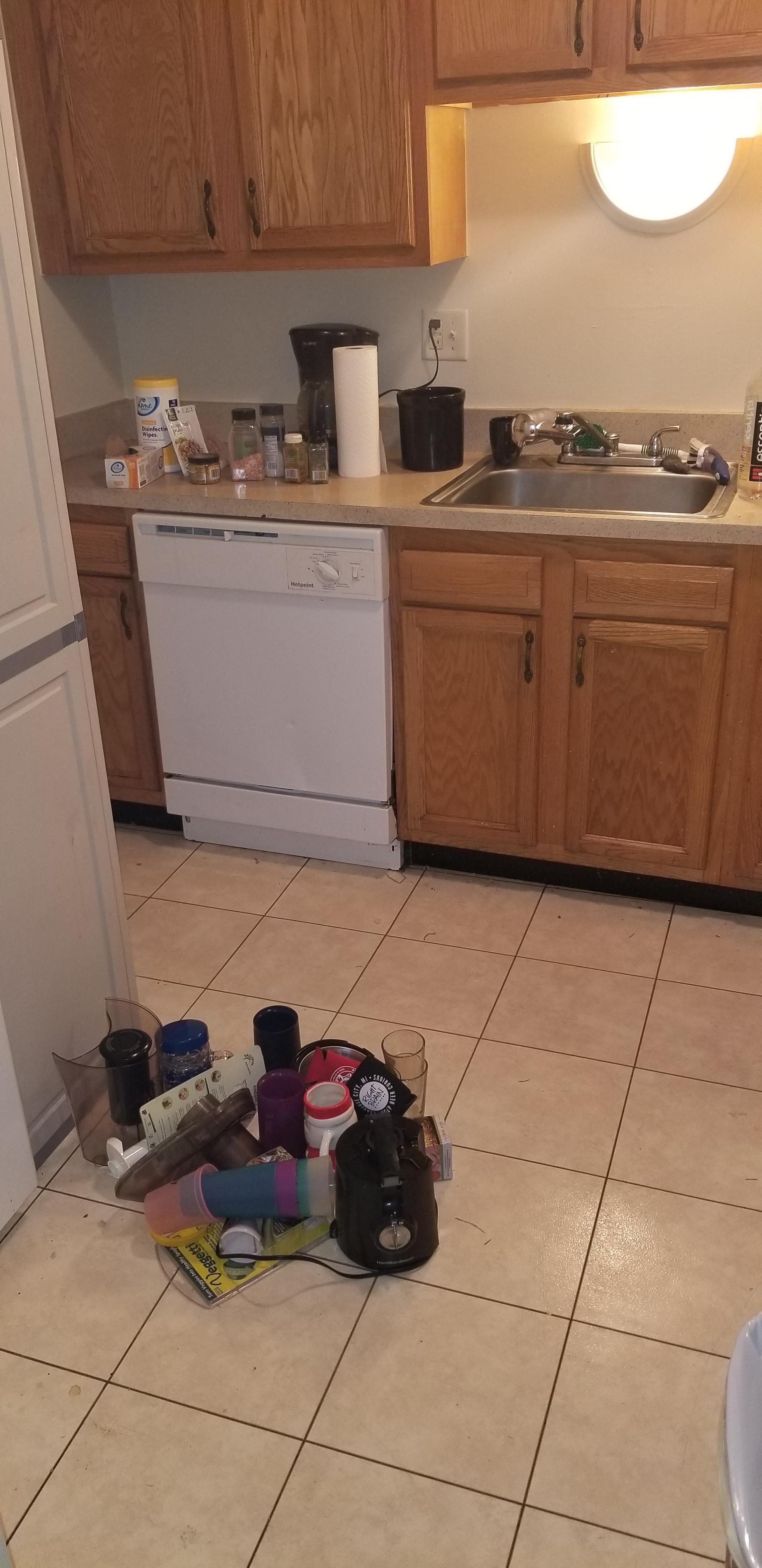 Kitchen moving along! Small donation pile on the floor. Doing spices