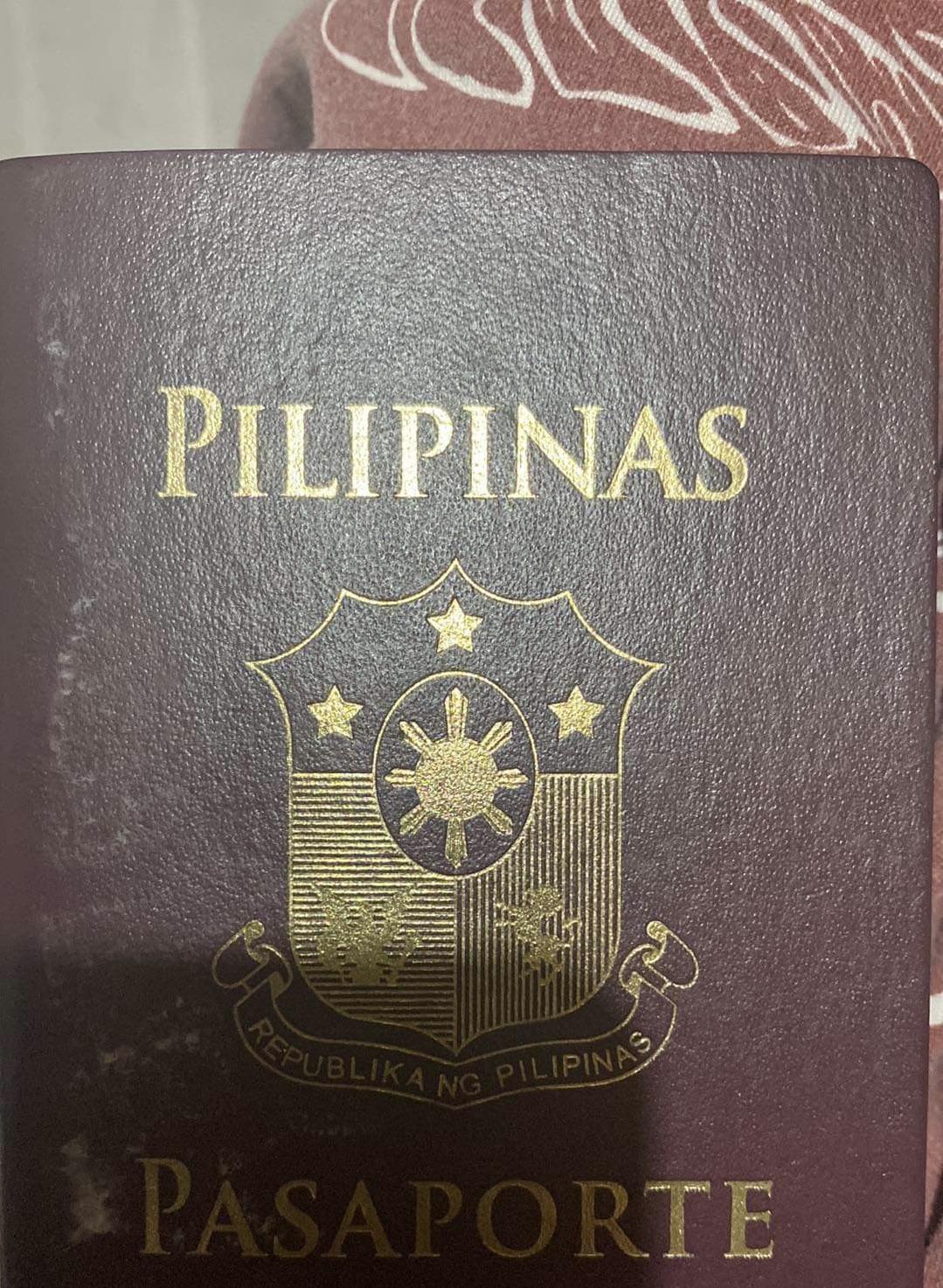 Badly need advise, is this still valid passport? The cover is faded or