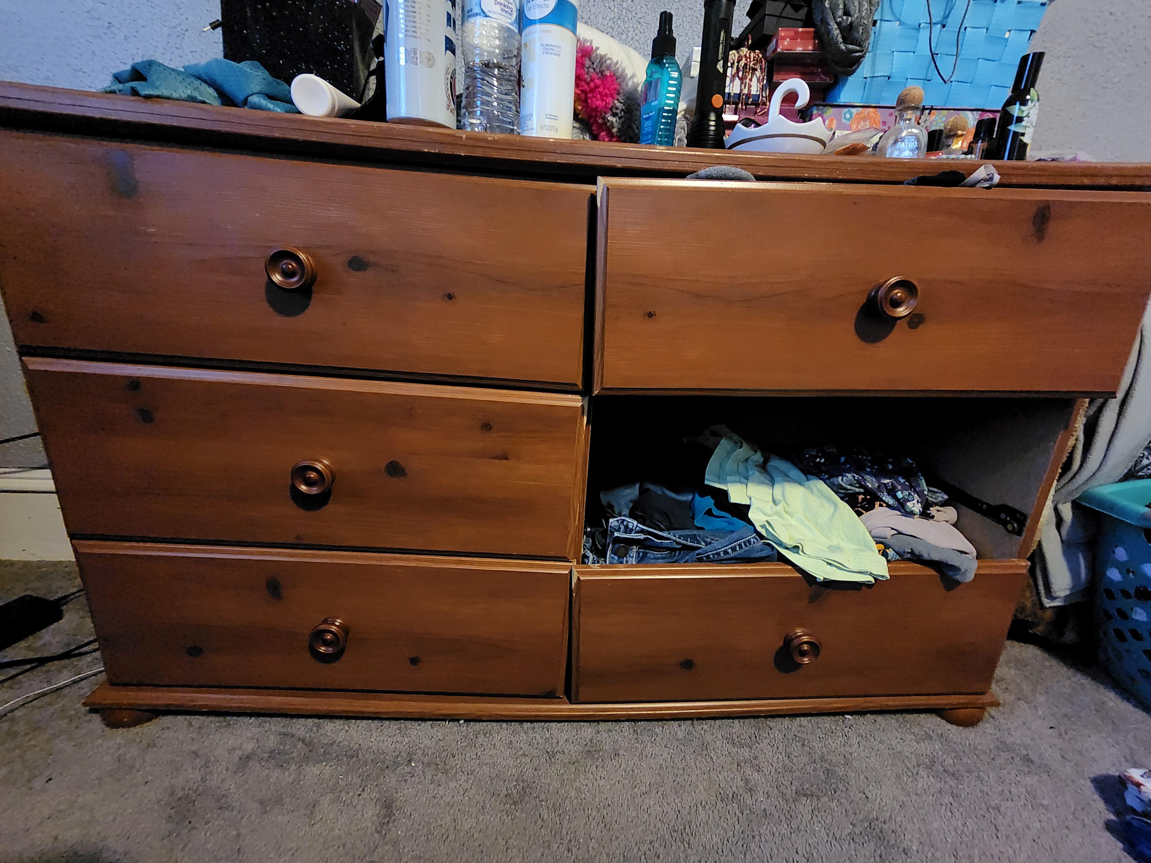Dresser drawers overlap. Older Dresser used to work fine until about 6 months ago. Drawer that's