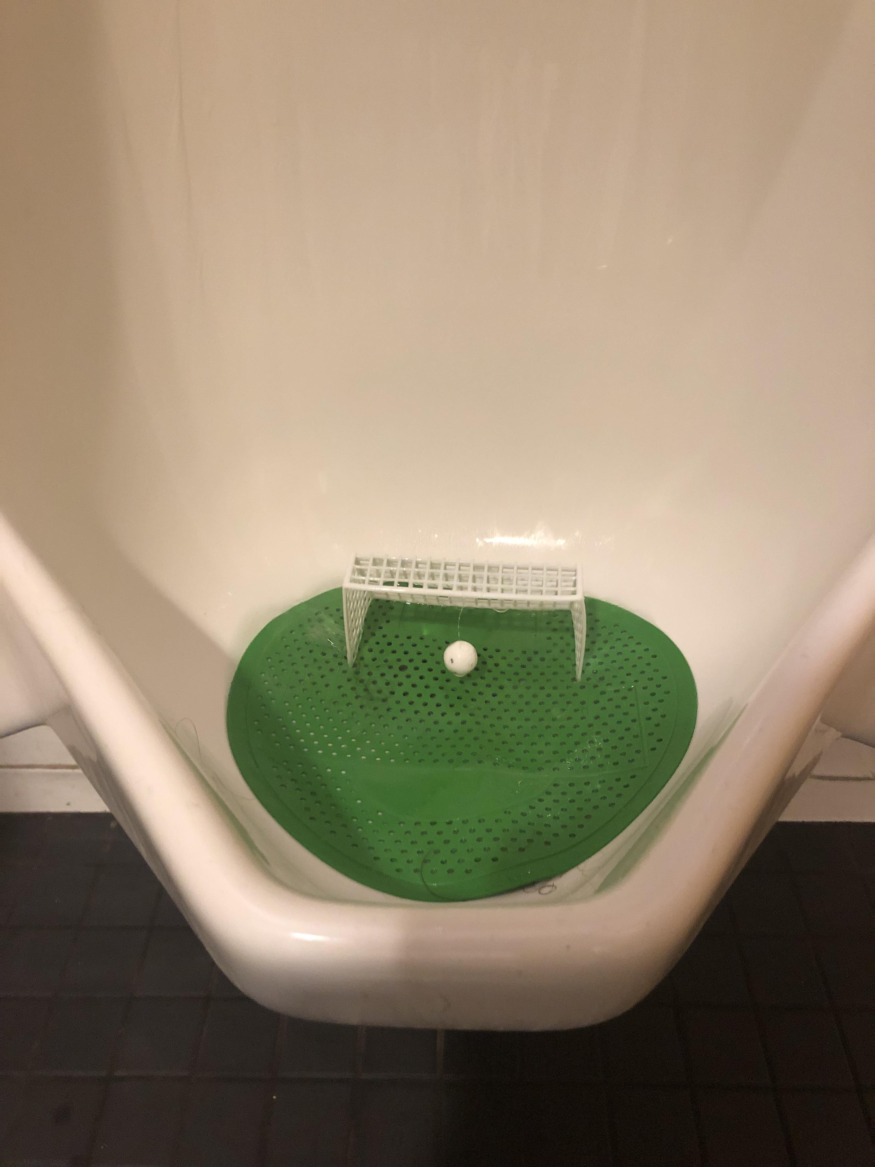 This urinal has a soccer goal to inspire guys to aim. r/mildlyinteresting