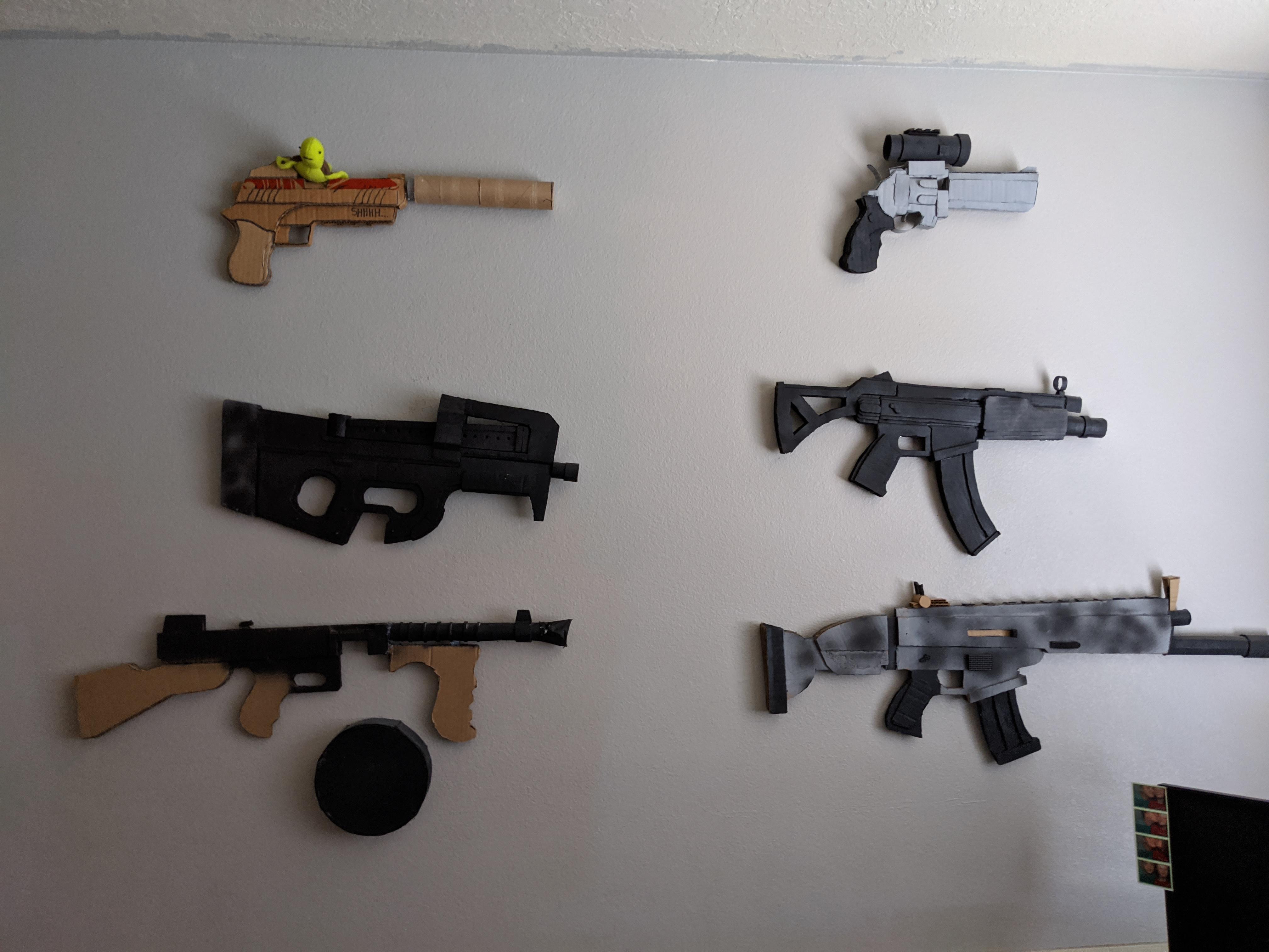 My wall of Fortnite Guns!!!! All made from cardboard, and designed by