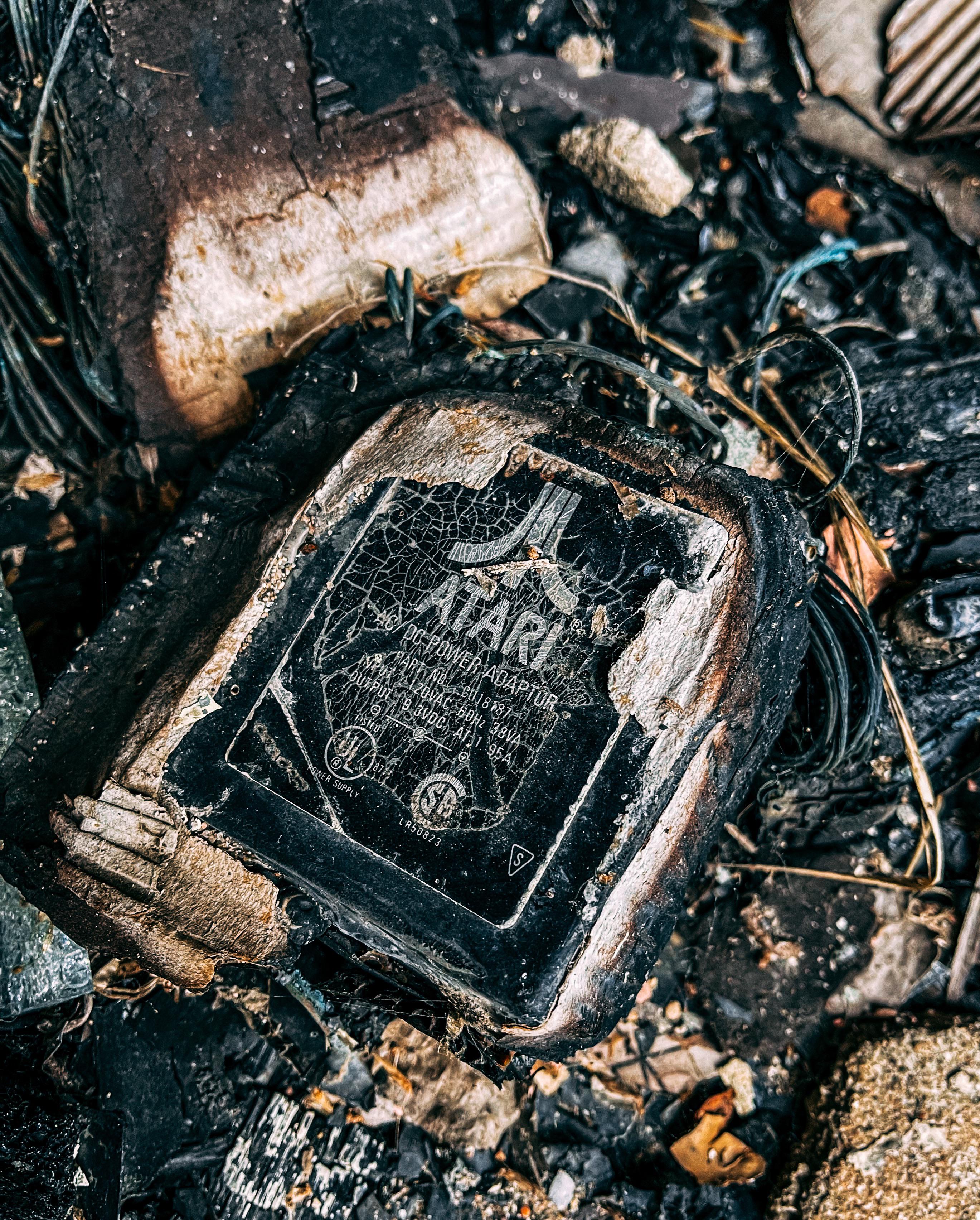 Multiple Atari power adapters damaged by a fire inside an abandoned