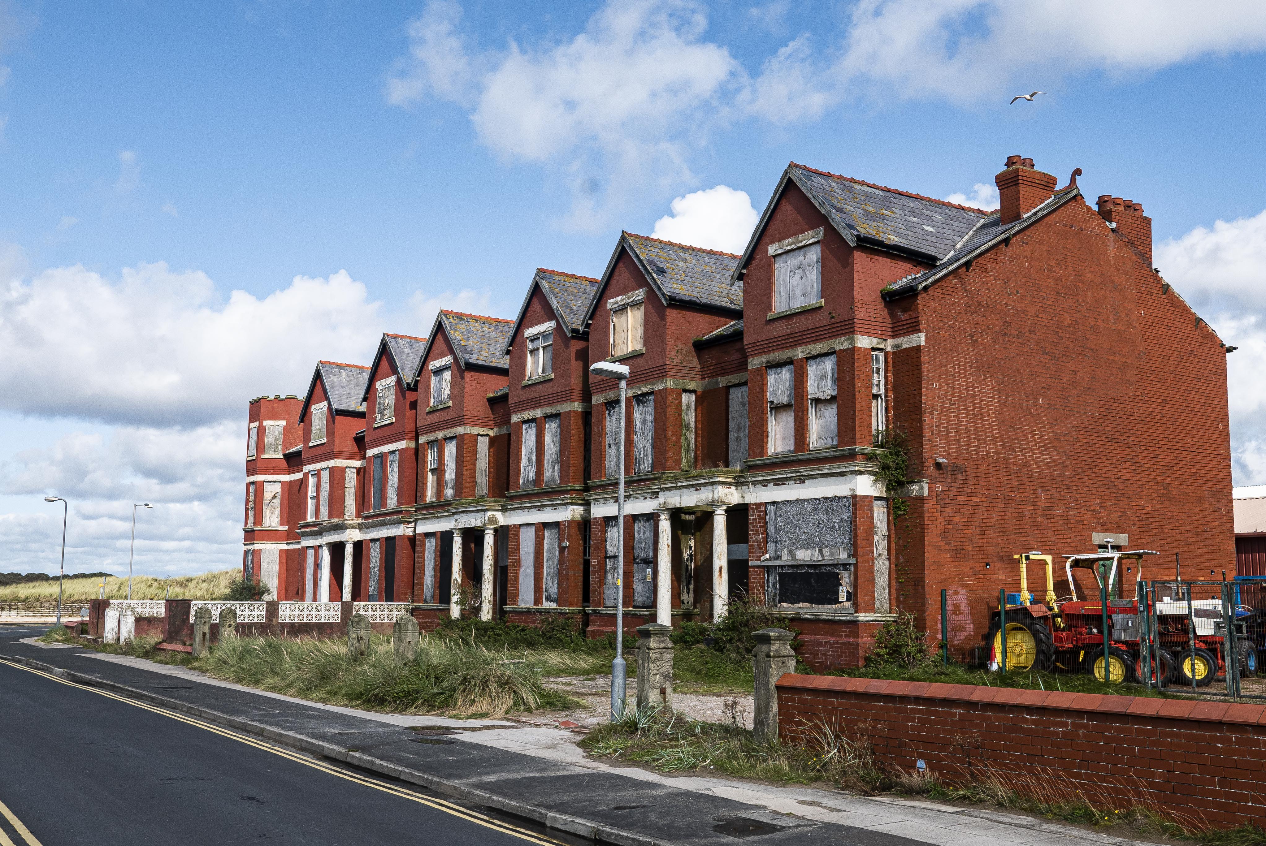 Row of houses overlooking the sea near Southport, UK. r/AbandonedPorn