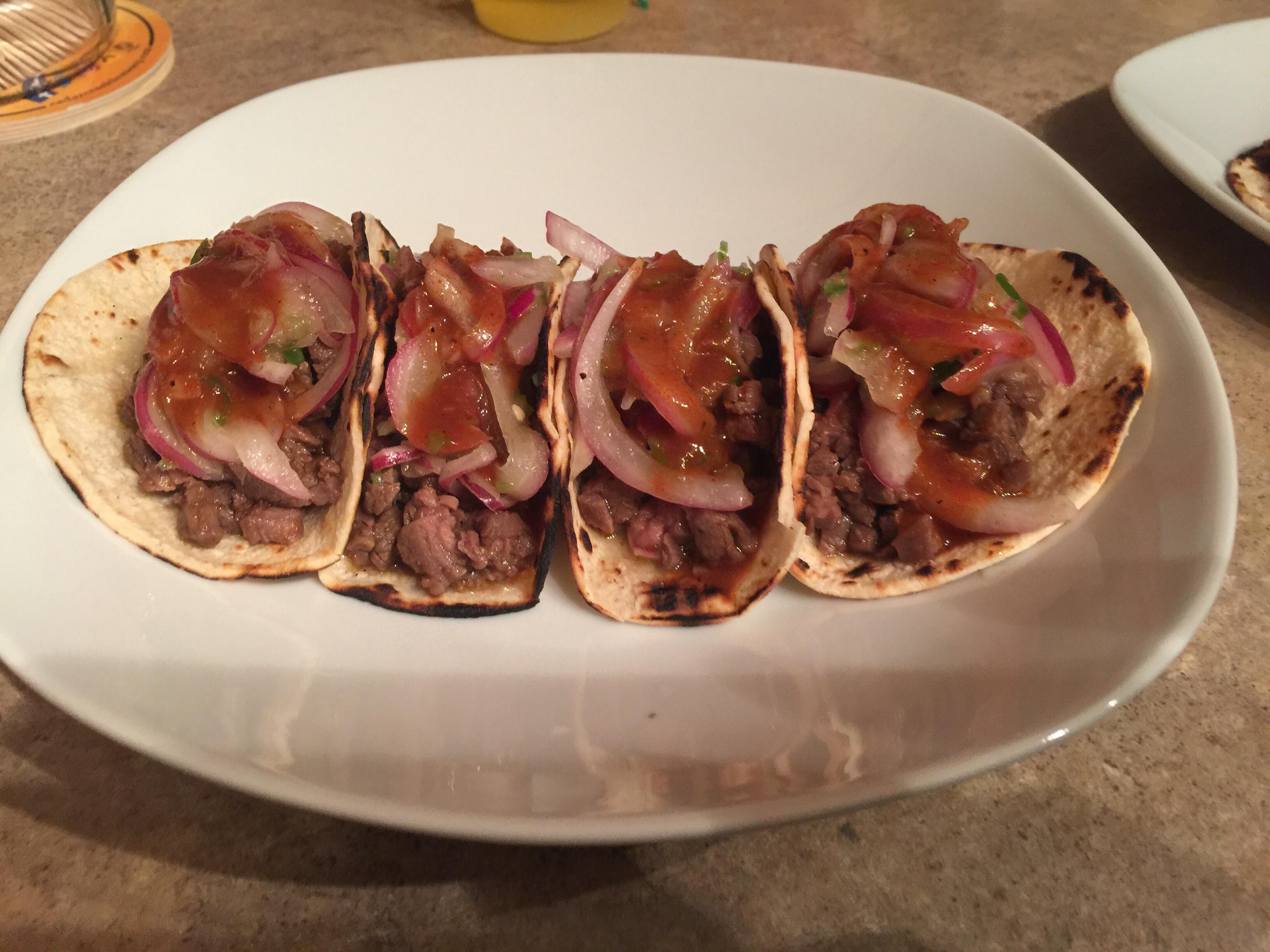 Homemade beef street tacos with serrano onions and chipotle hot sauce