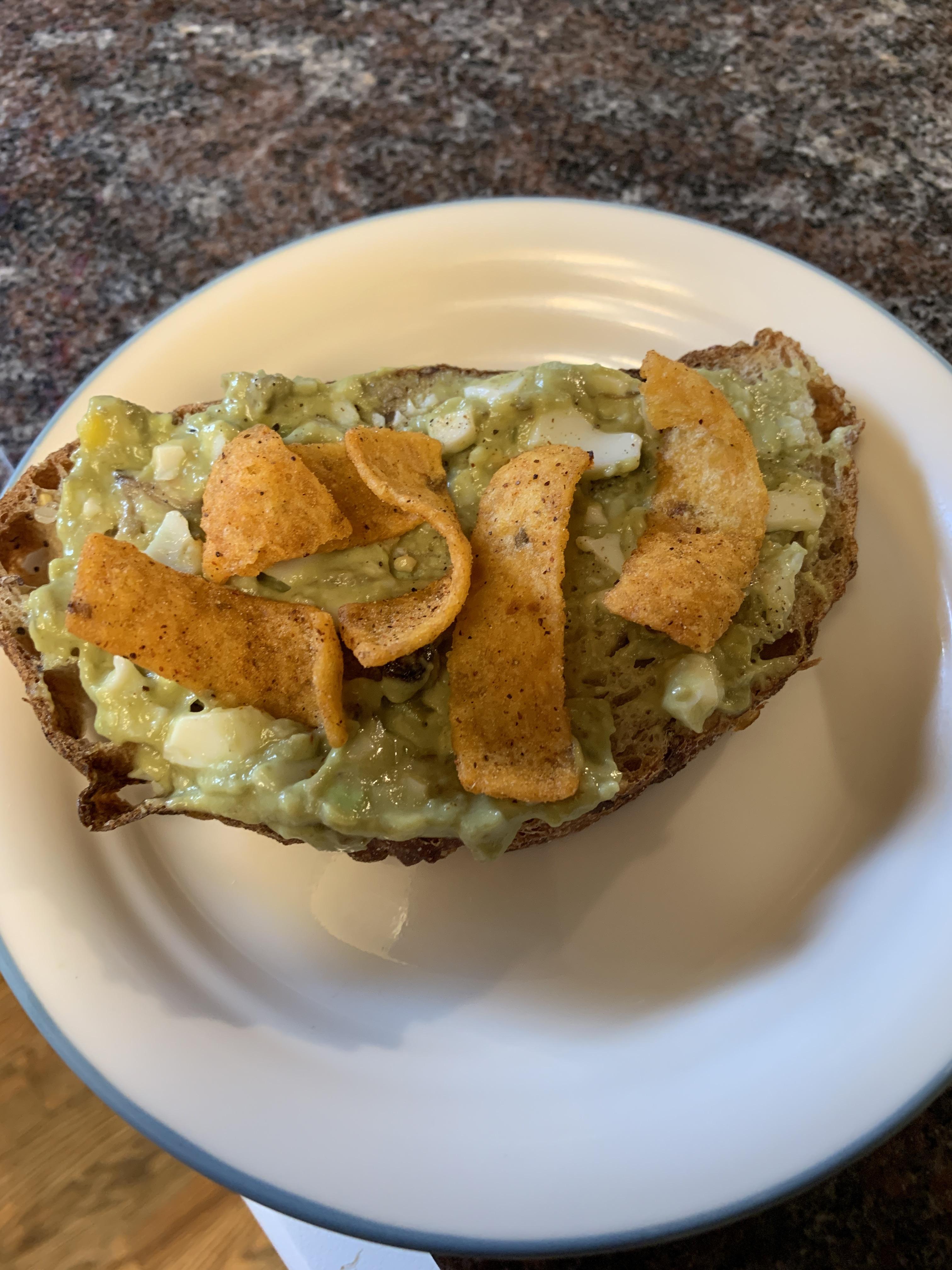 A hard boiled egg mashed with avocado, mayo, Dijon mustard, and curry