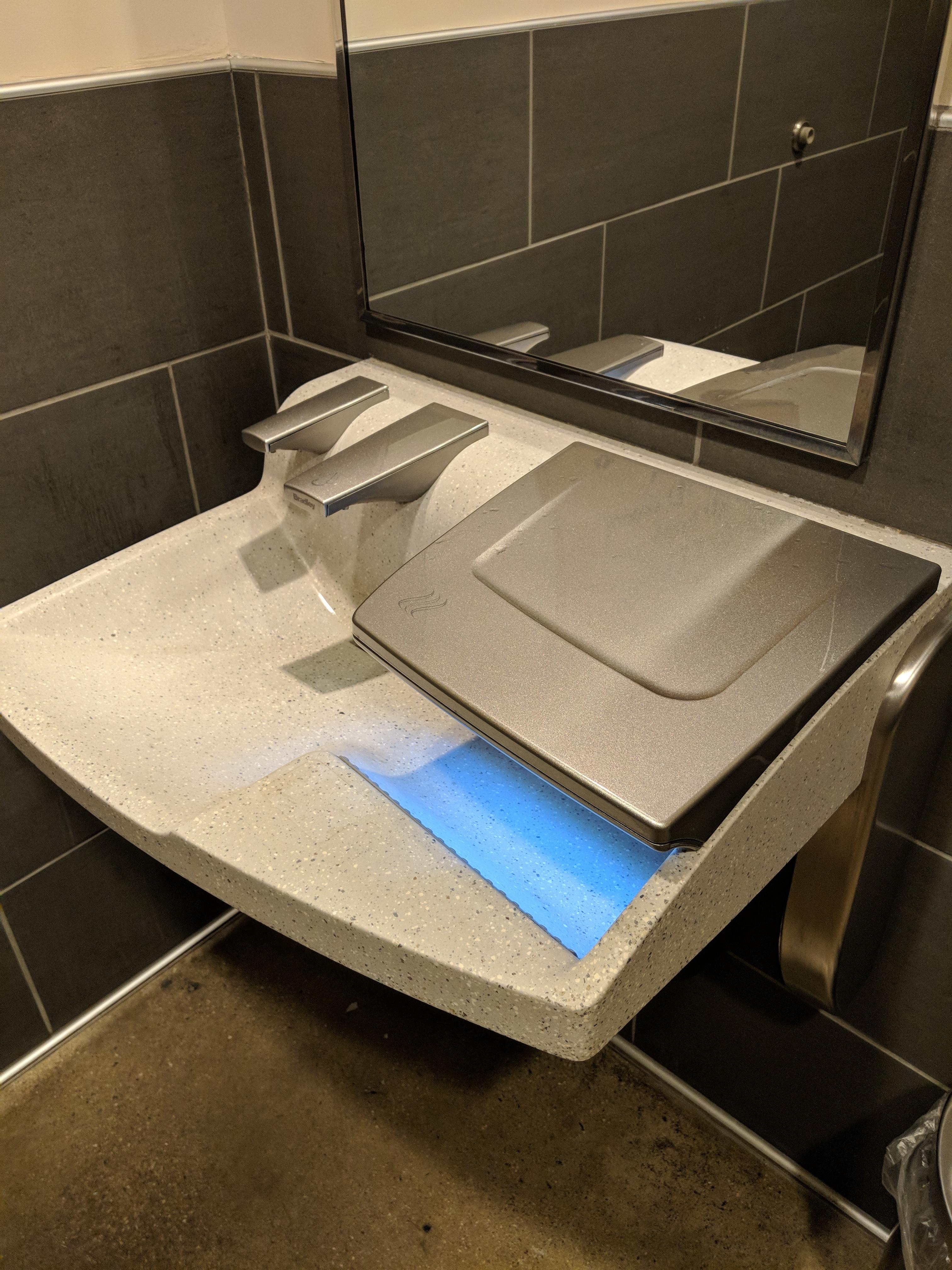 This futuristic sink with a built in soap dispenser & air dryer built