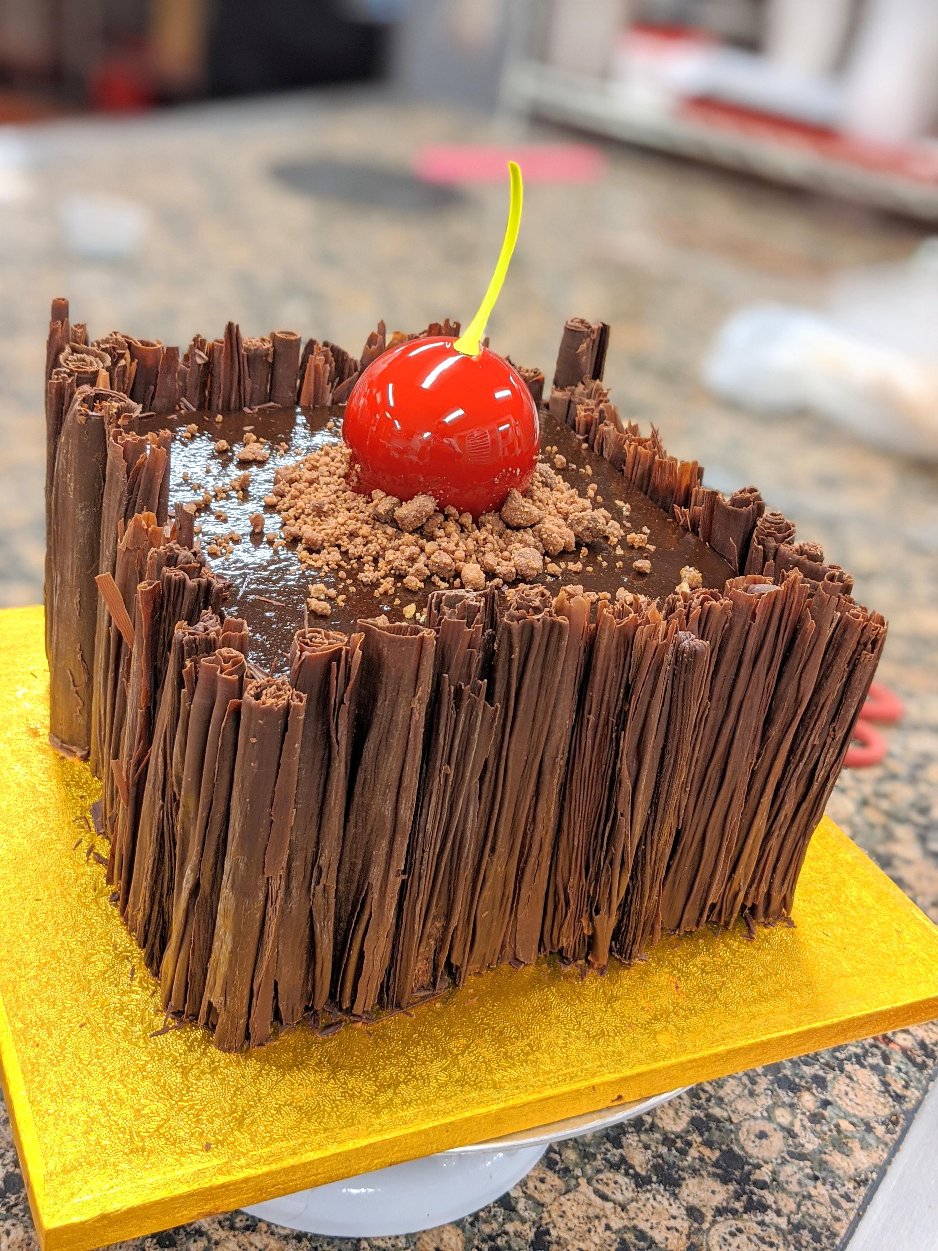Black forest cake layered with dark chocolate mousse, white chocolate