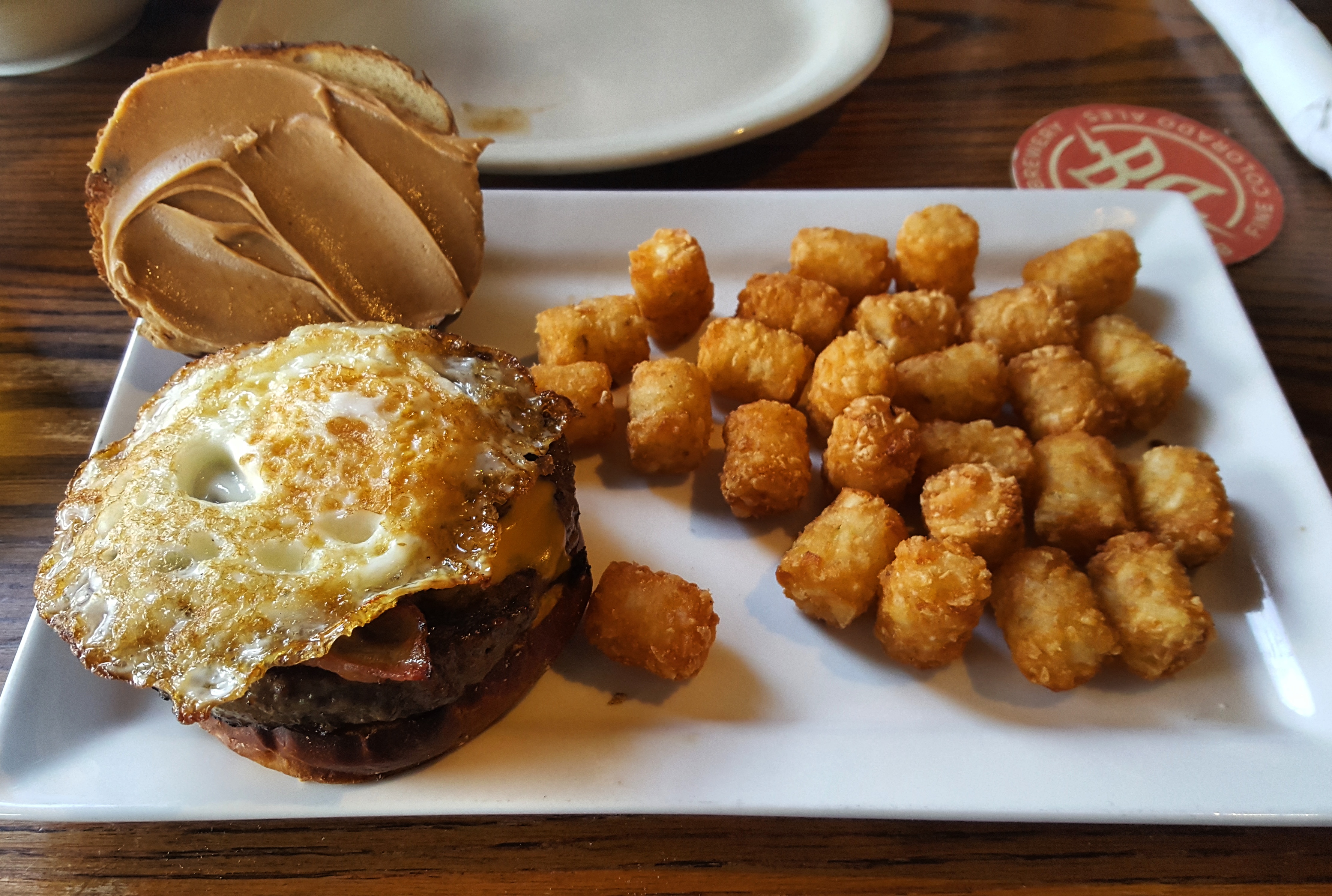 [I Ate] A delicious bacon, egg, & peanut butter burger with tots. r/food