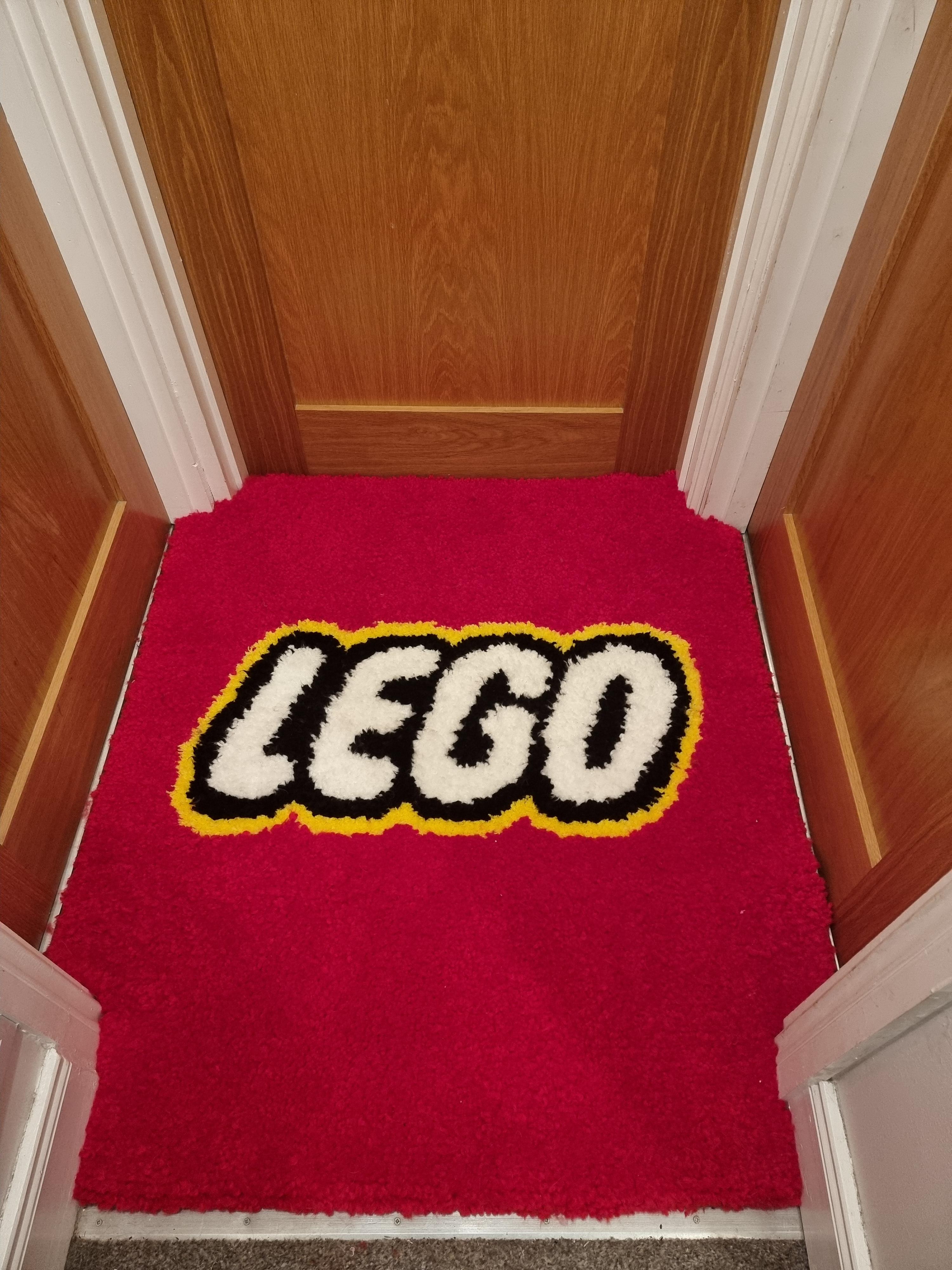 Wife finished making a new rug for our landing! r/lego