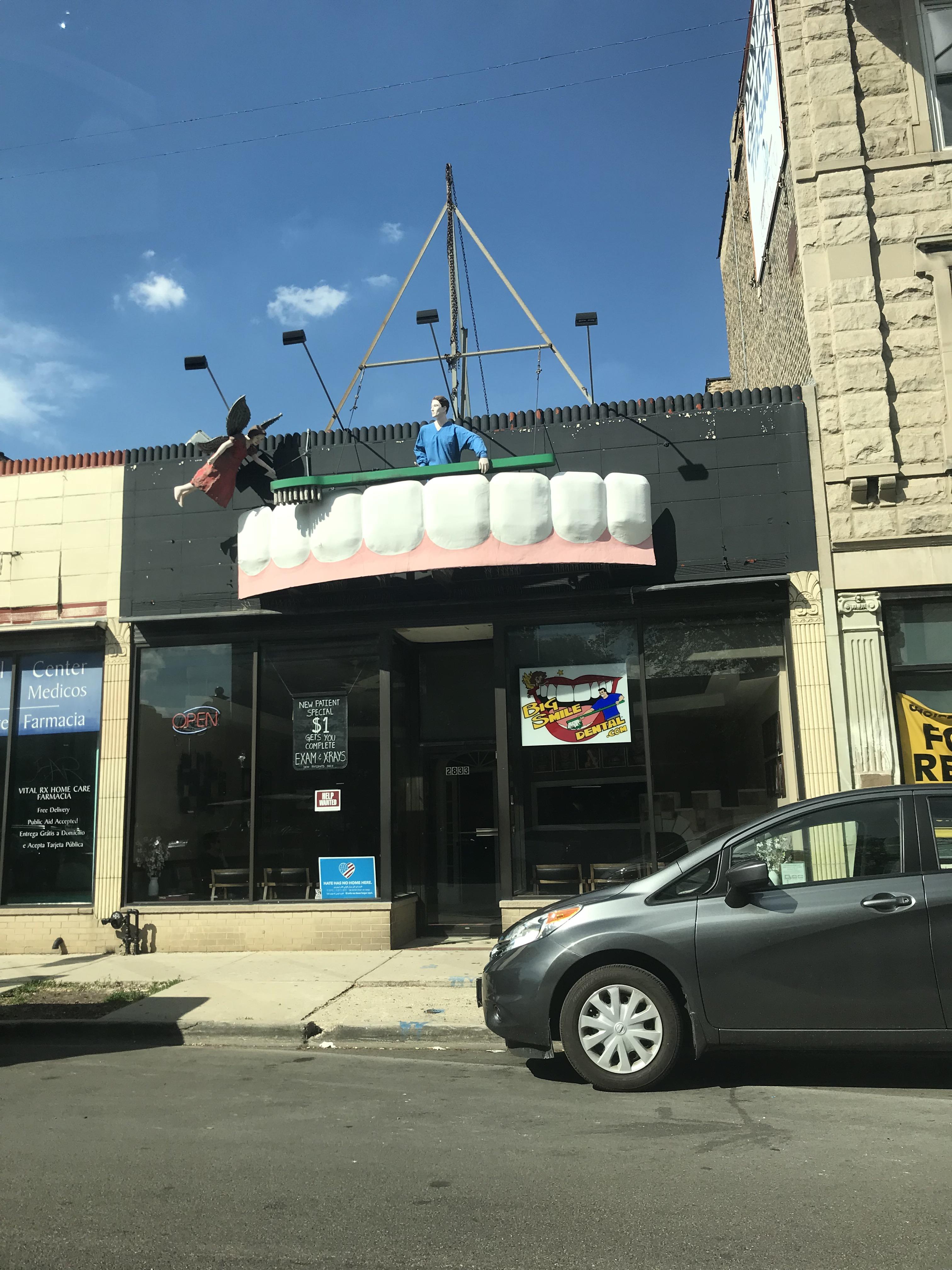 This dentist office in Chicago has a man cleaning giant teeth and a