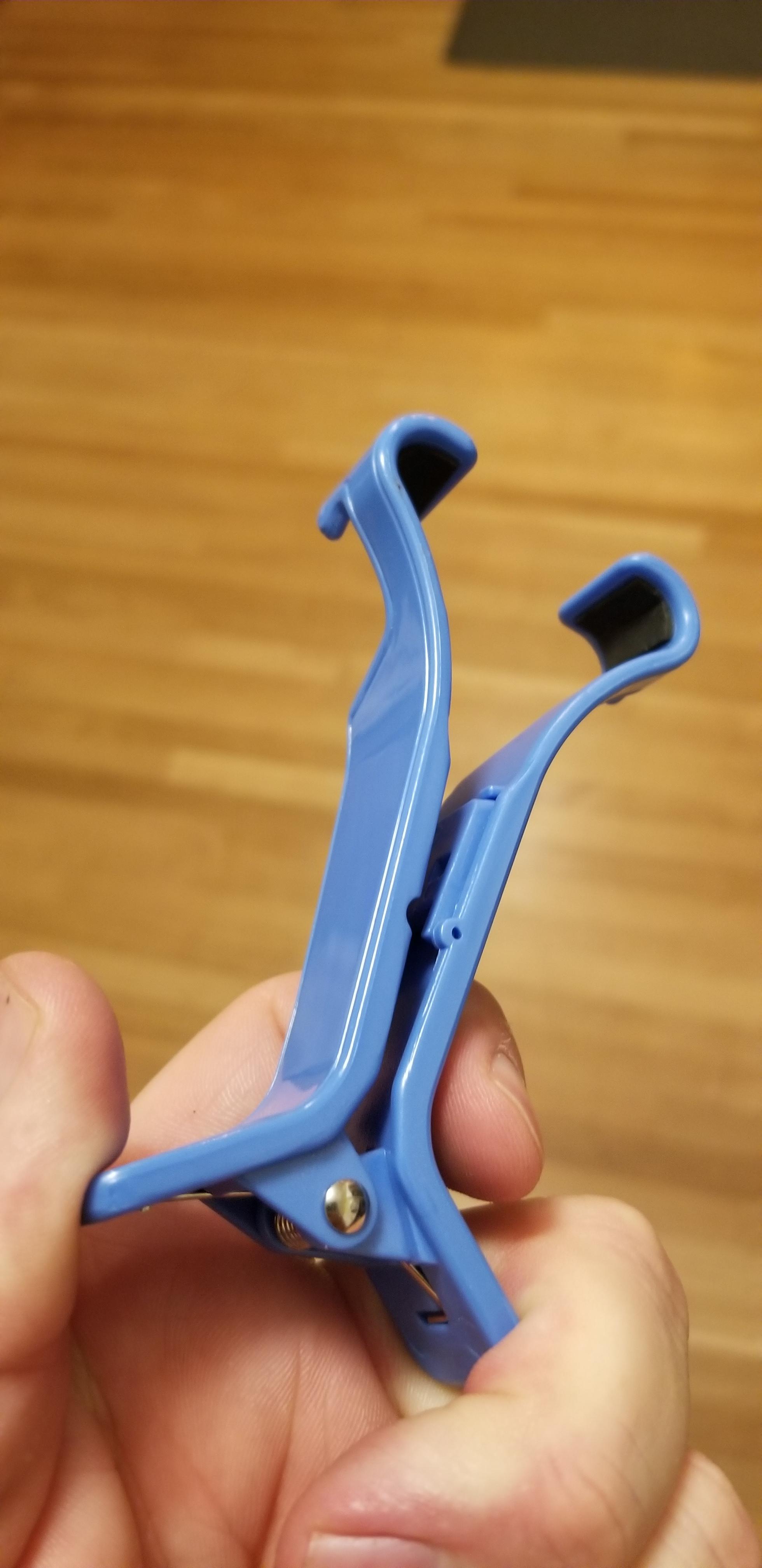 Plastic spring clip of some sort. The hooks at the end are padded with