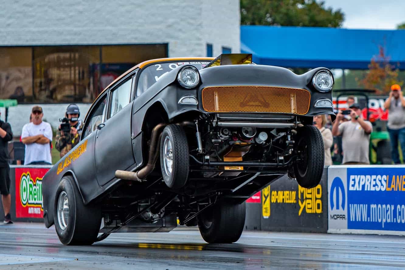 Mike Finnegan's 55 Chevy Blasphemi popping a wheelie. Drag racing is