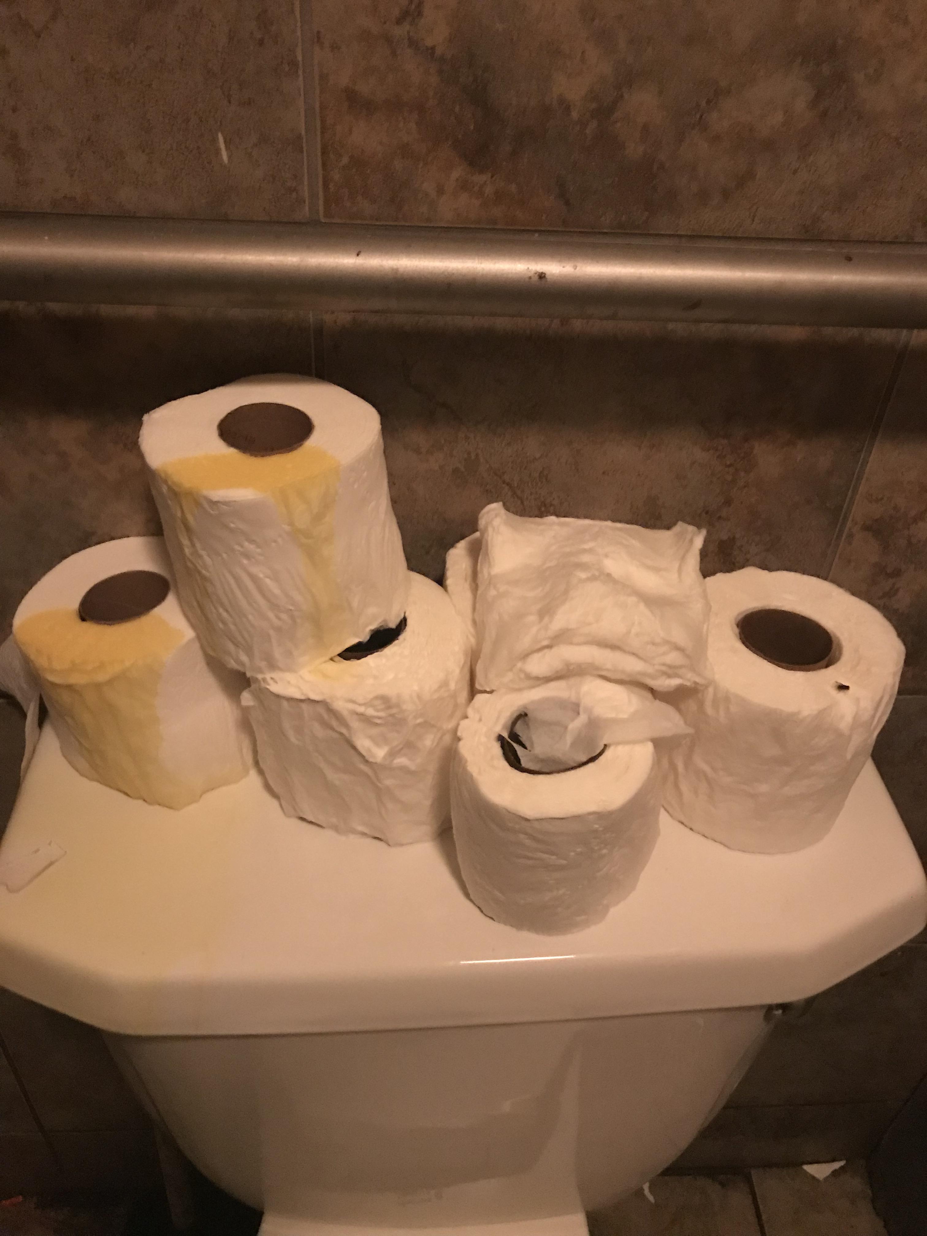 The men’s room at my local bar where gents aim for the toilet paper